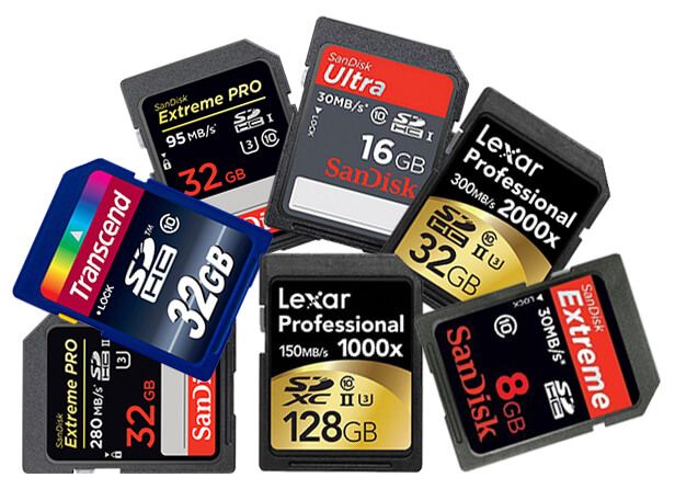 A collection of various memory cards and SD cards from different brands including Lexar, SanDisk and Transcend scattered together.