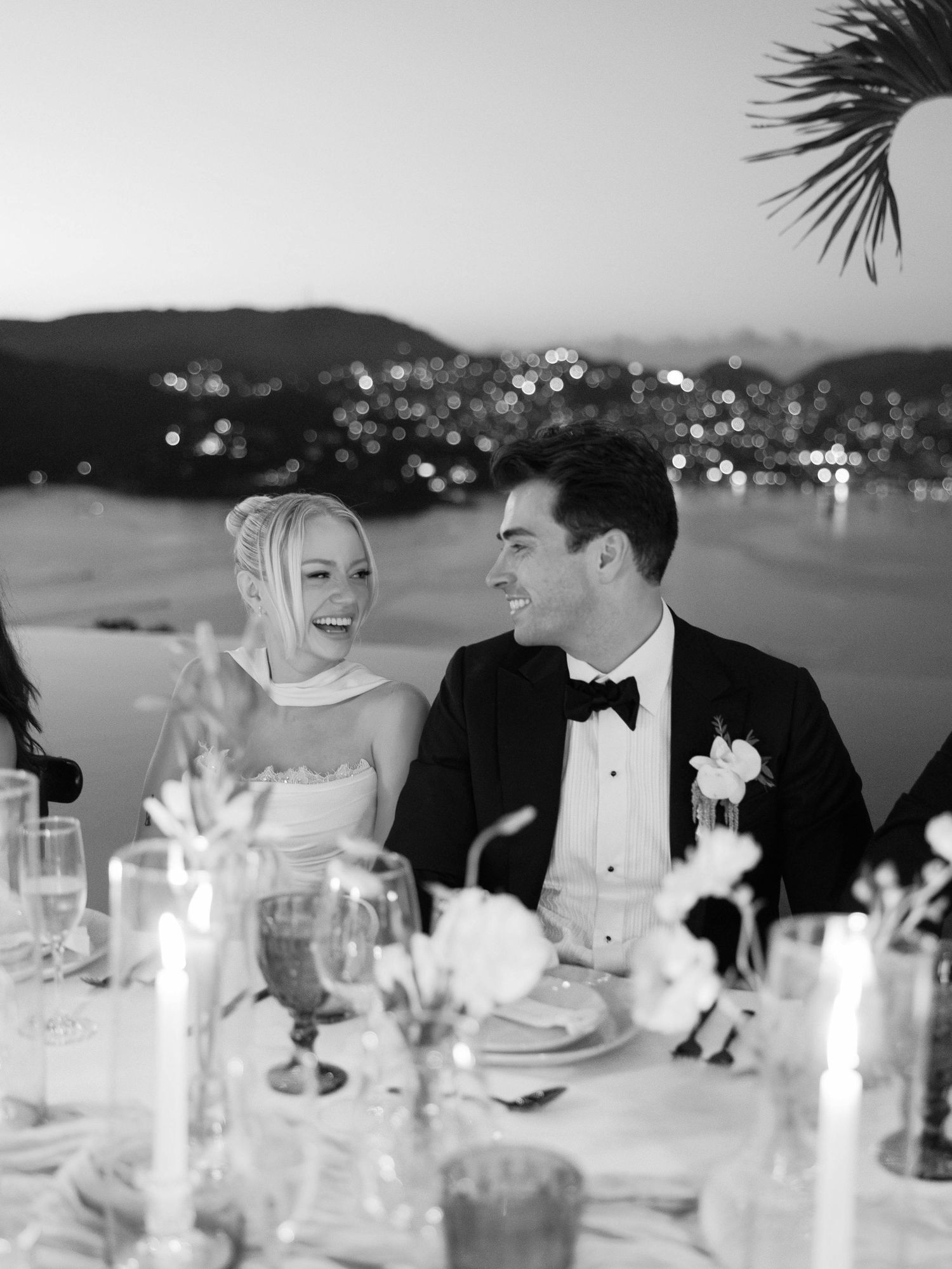 An elegant candlelit dinner reception at dusk with mountain views.
