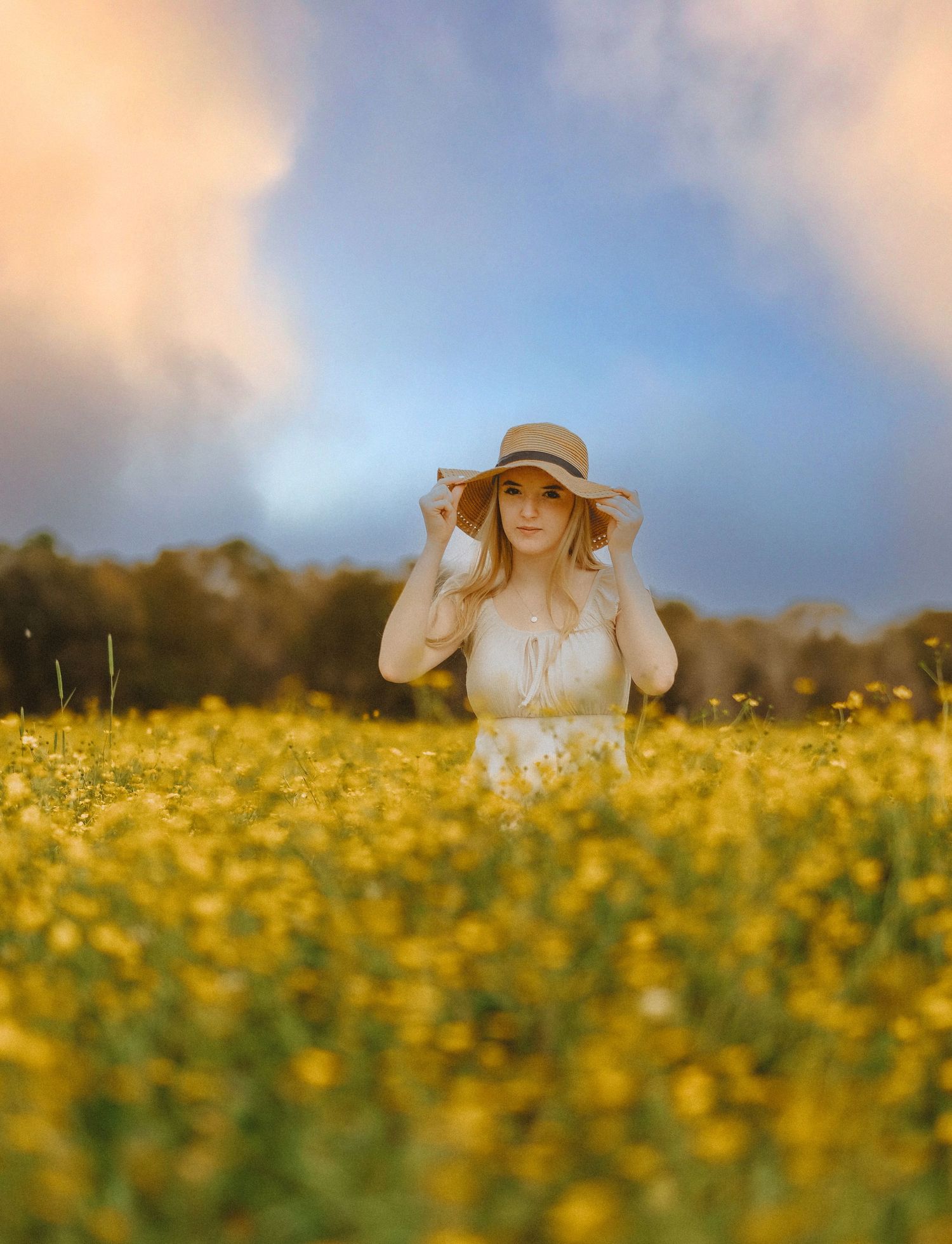 Photo of a girl seated in a field of flowers