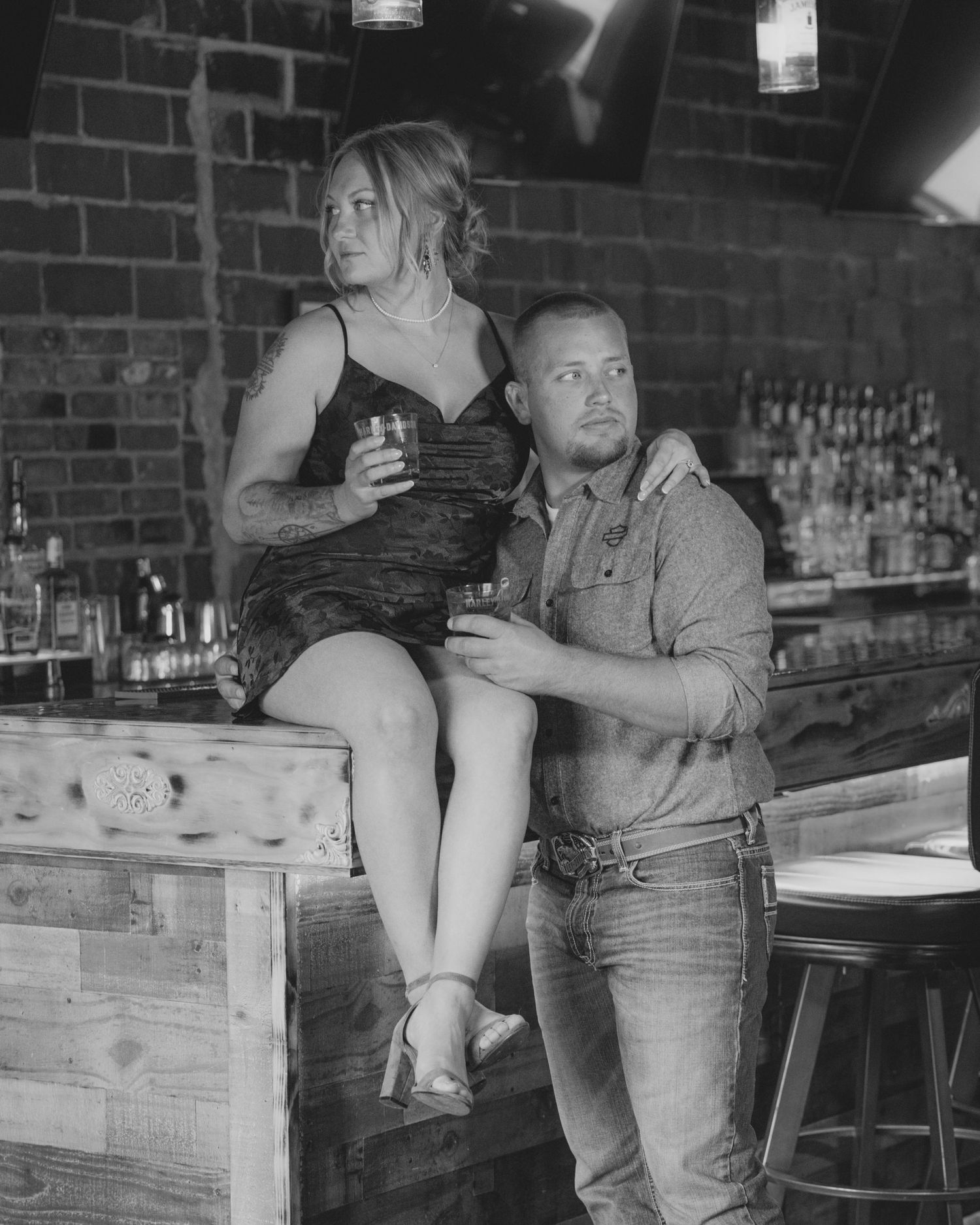 Black and white photo sequence showing people at a bar counter engaging in playful interactions in a vintage setting.