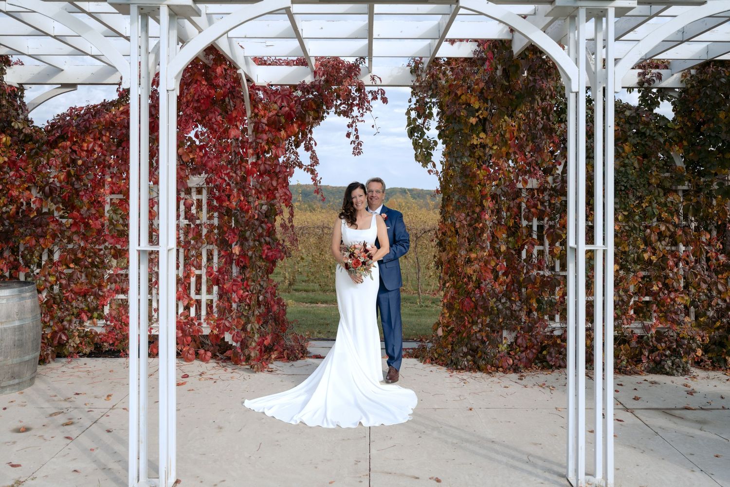 bride and groom hold hands, bride looks back at the camera during sunset wedding portraits in Hudson, WI.