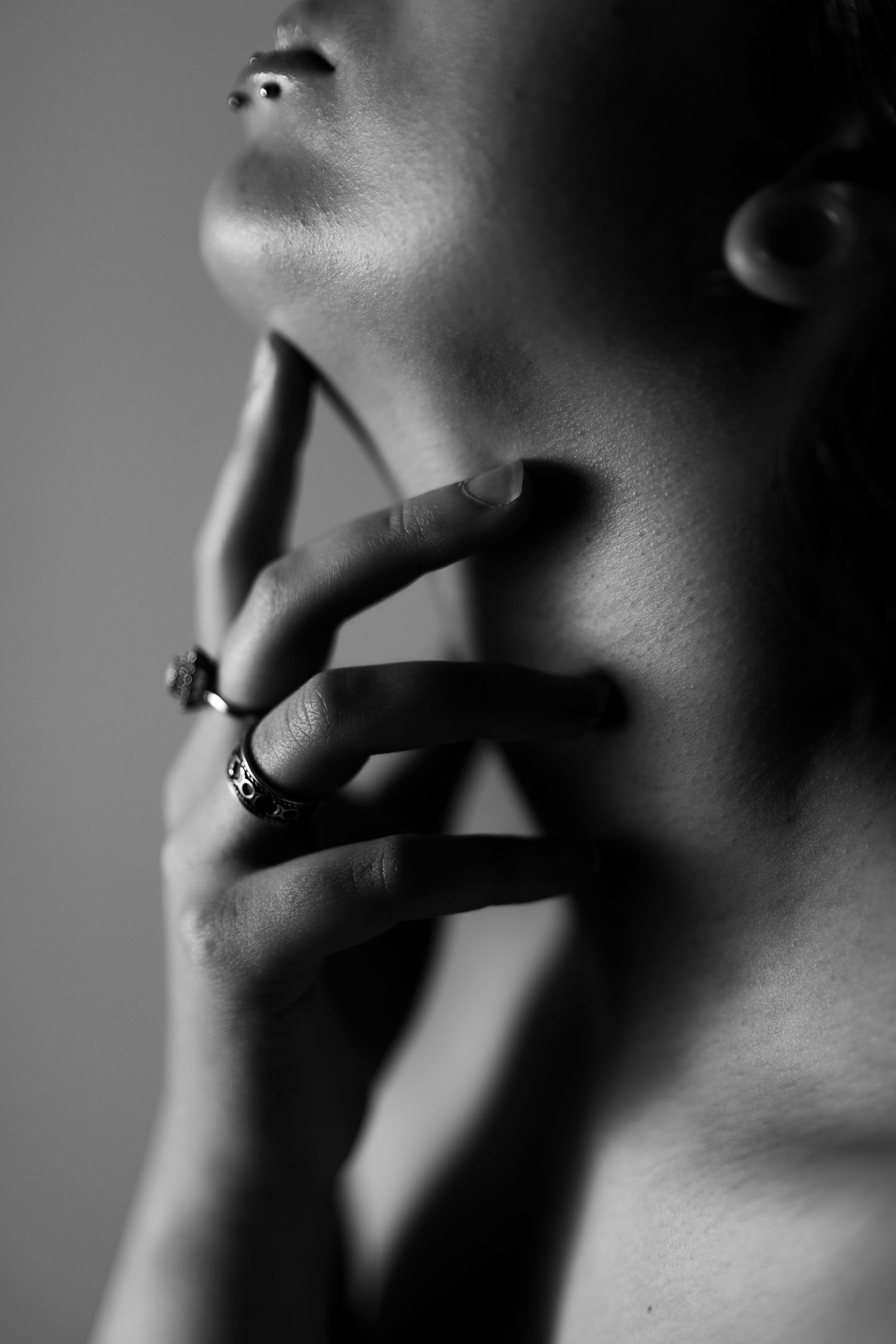 Black and white artistic nude photographs showing abstract body forms and shadows against dark backgrounds.