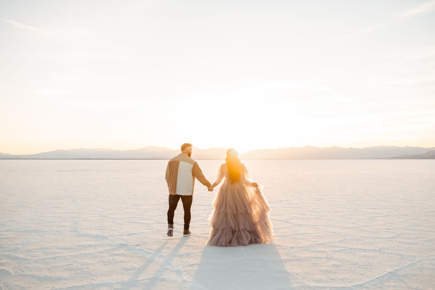 Couple holding hands at the Salt Flats by Utah engagement photographer Coley Cook
