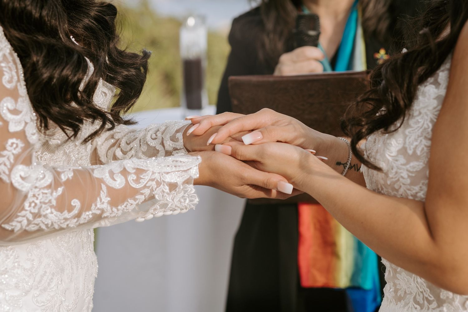 Close up of hands exchanging rings during an intimate wedding ceremony at Tom Ham's Lighthouse.