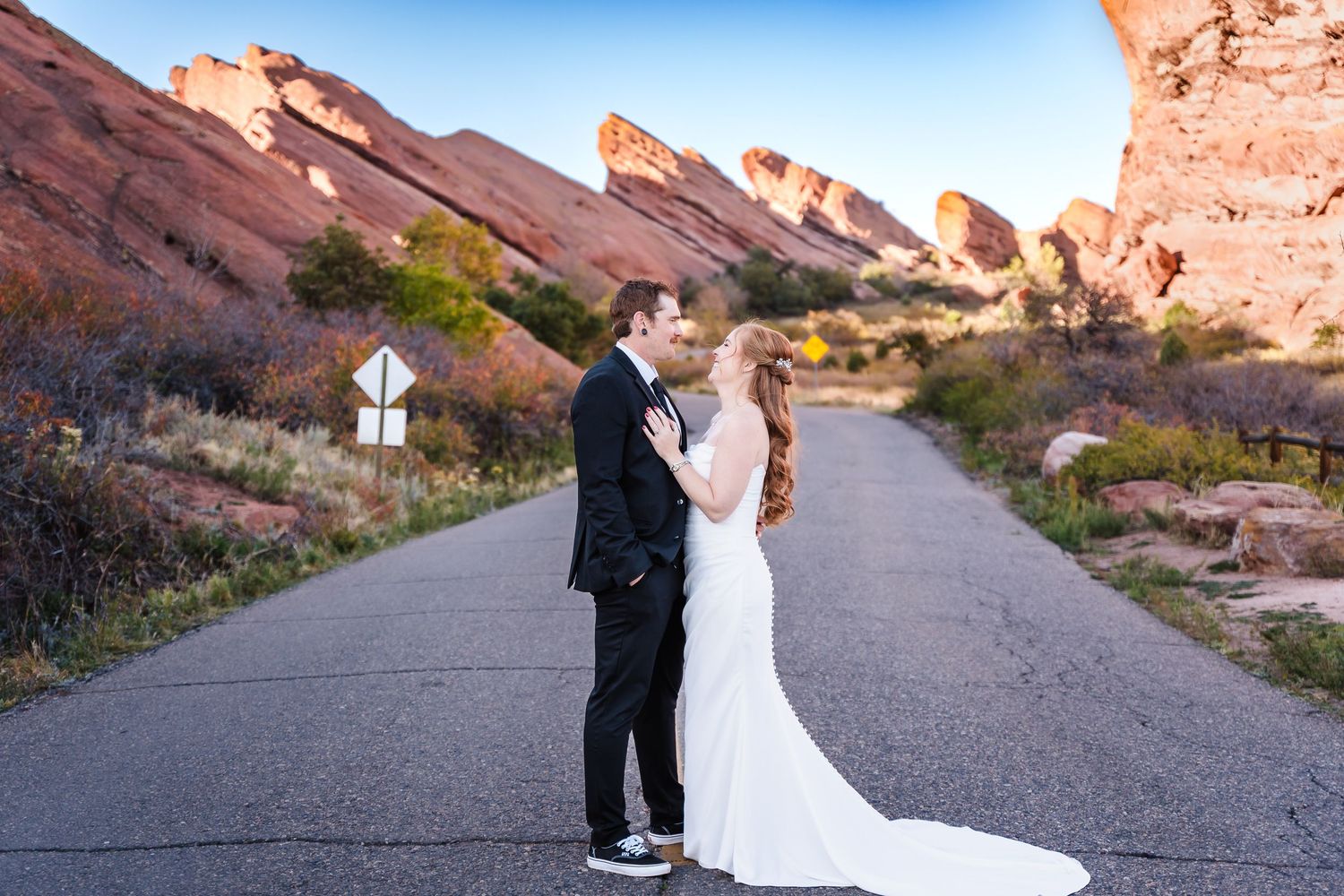 A couple shares a romantic moment at sunset among the stunning red rock formations of Red Rock Canyon.