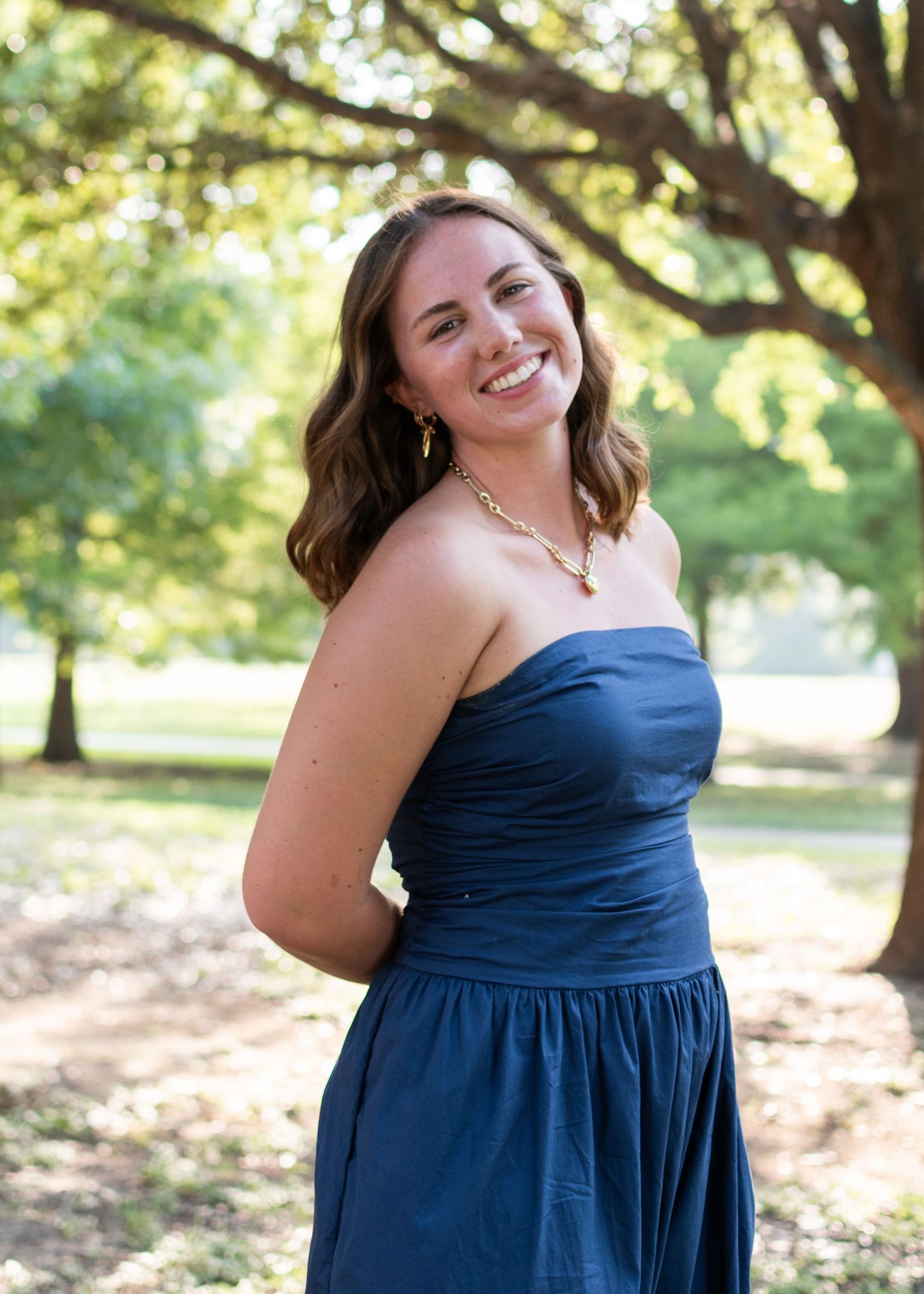 High school senior smiling during session at Butler Park in Austin Texas