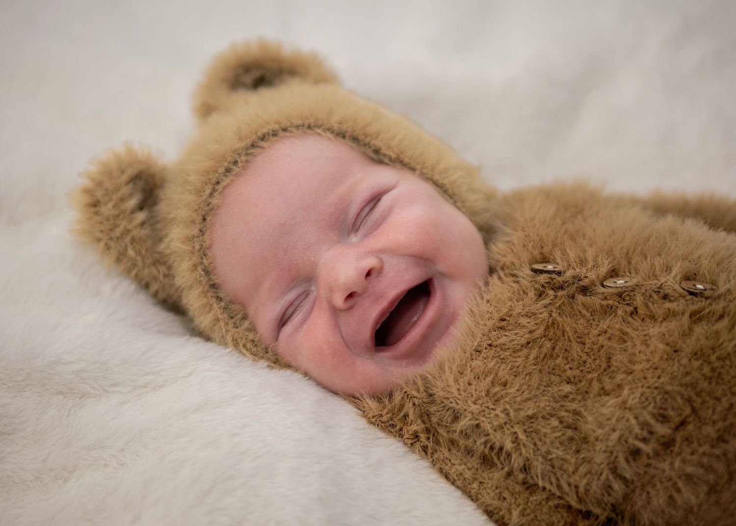 Newborn Photography - A series of tender moments between parents and their sleeping newborn baby shown in four connected photos.