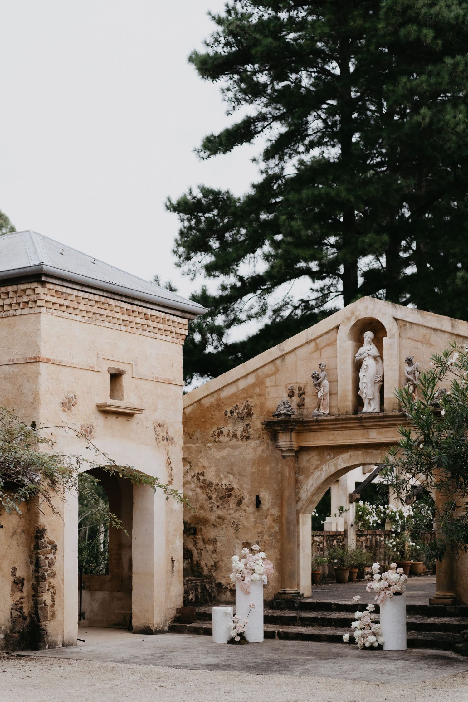 Wedding couple dancing and twirling in vintage architectural setting.