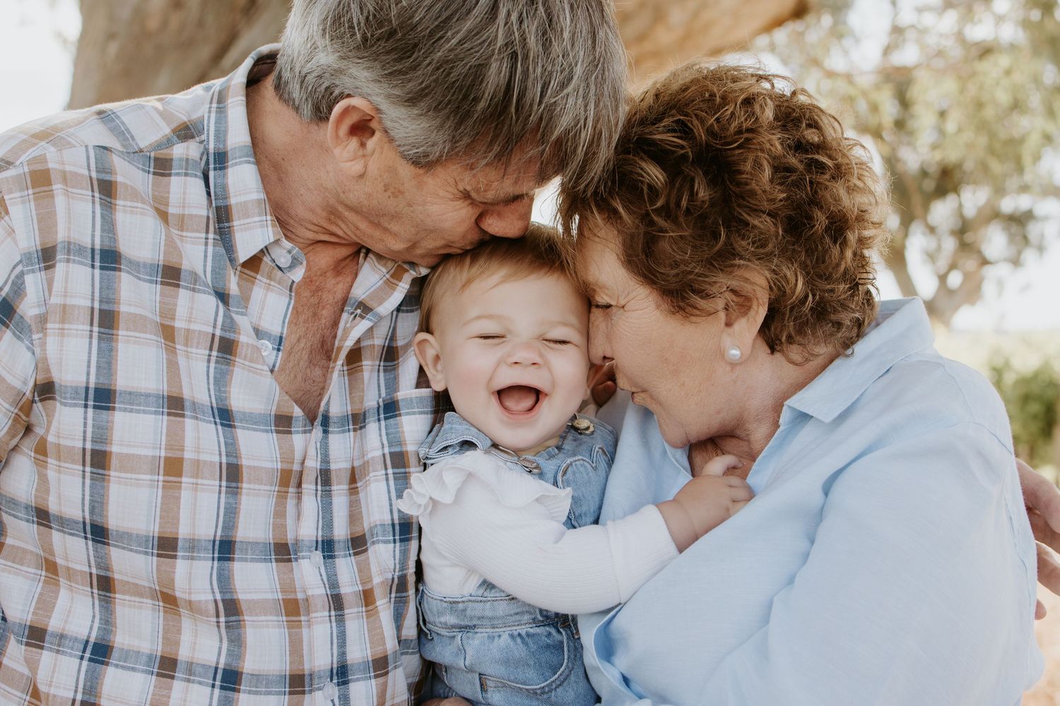 Creating memories with grandparents, parents, and grandchildren in a timeless family photo.