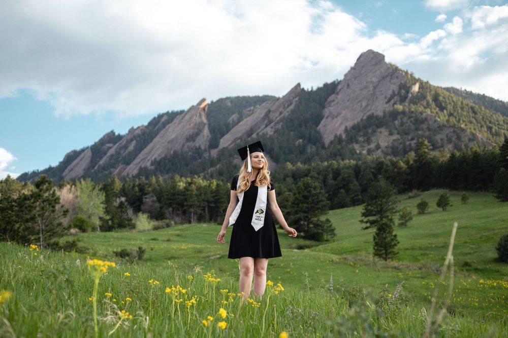 Graduation celebration with Flatiron mountains and wildflowers in background.