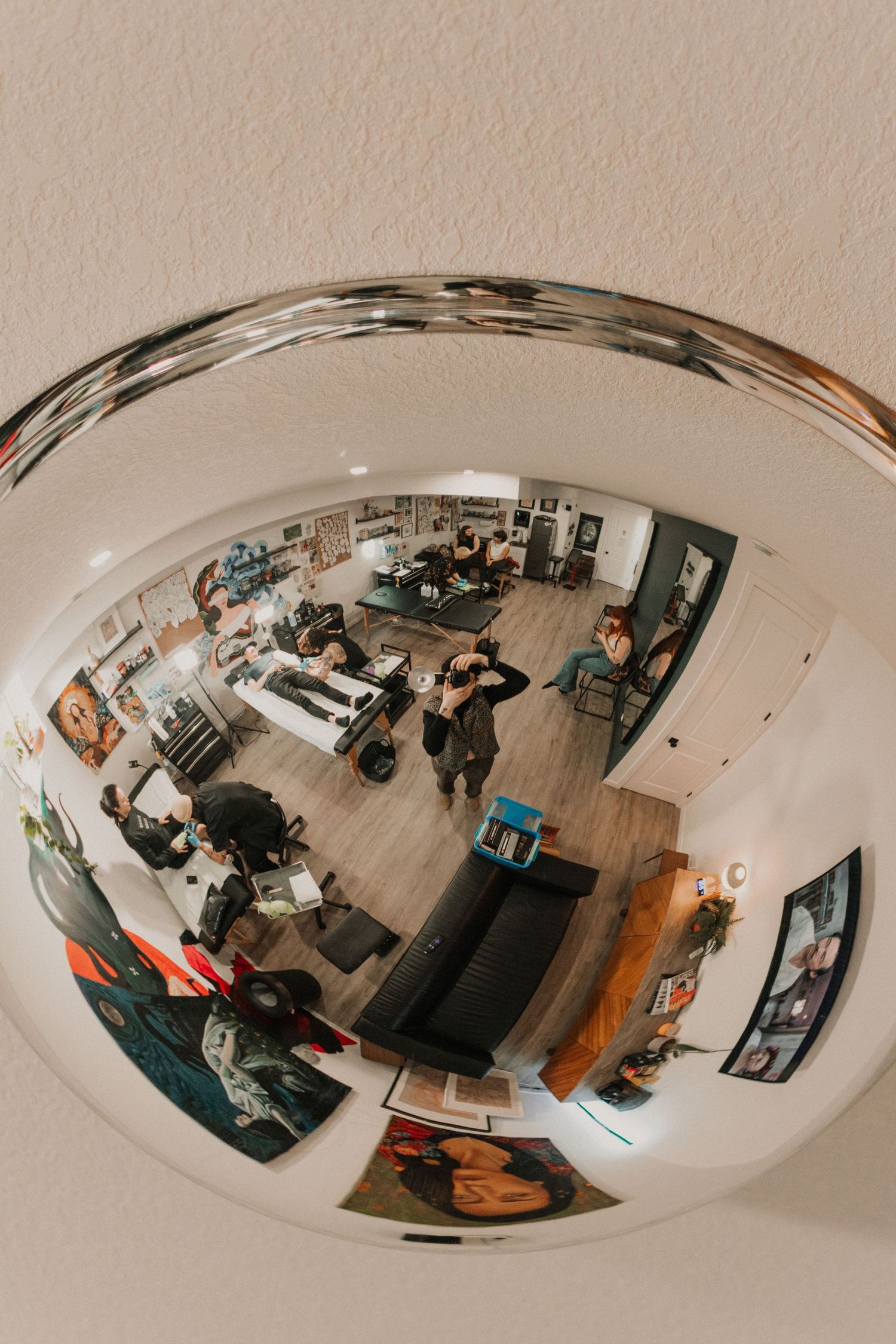 Wide angle fisheye view of a modern office or studio space with furniture and equipment.