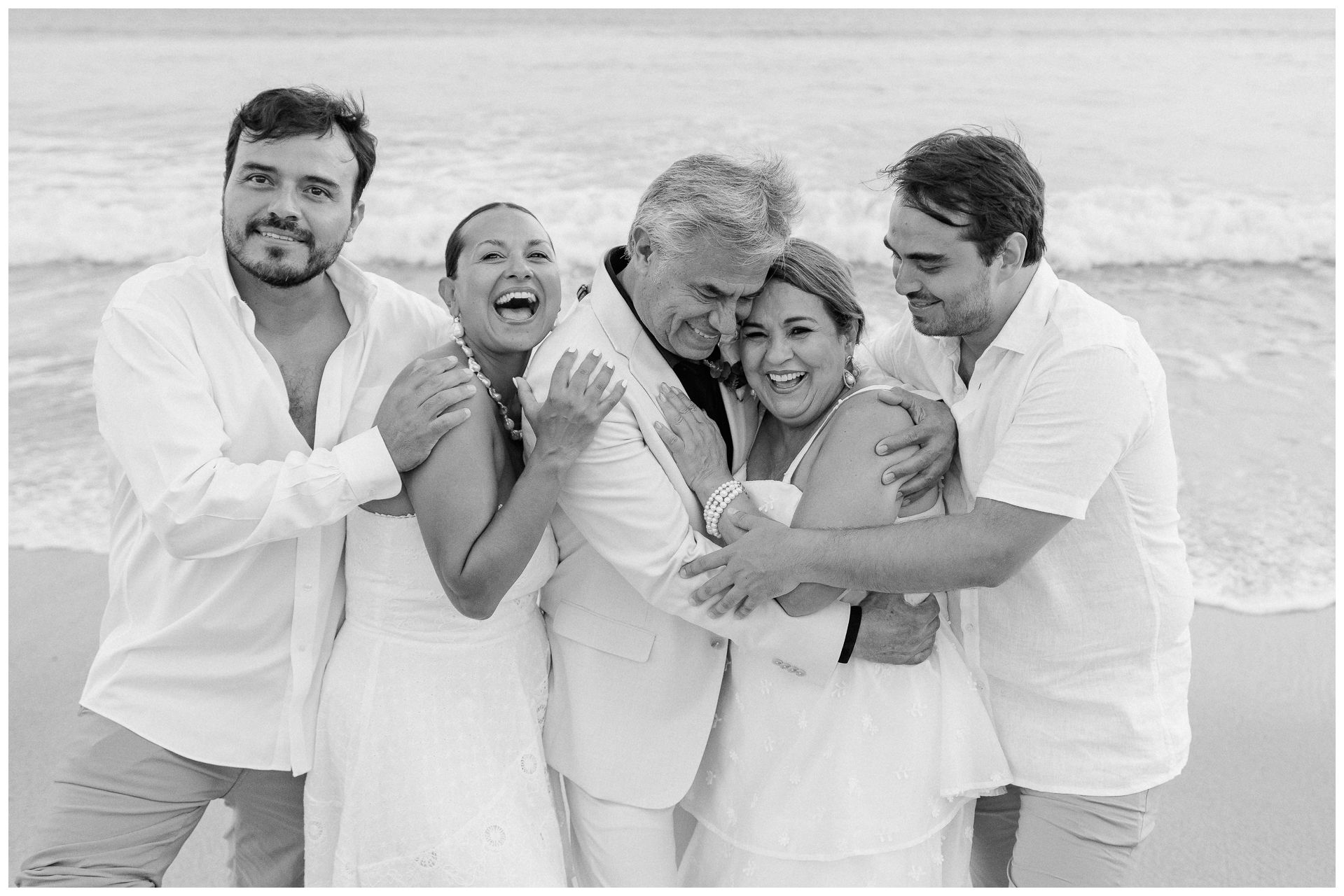 Family vacation in Dreams Bahia Mita with a beach photo session capturing laughter and embraces by the ocean waves.
