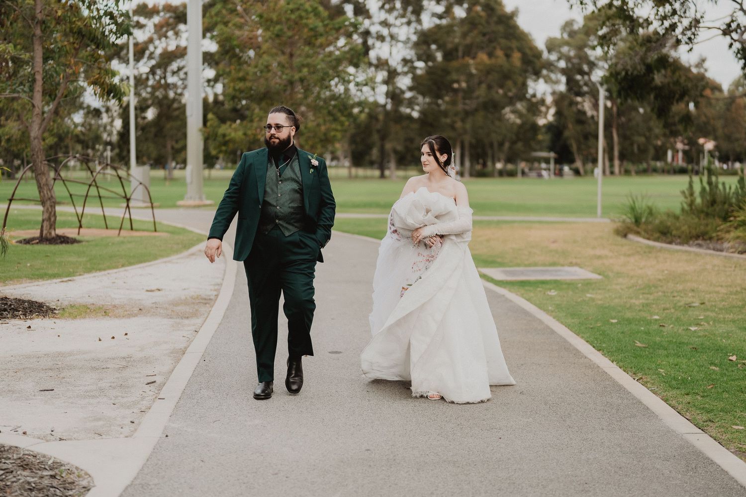 Harrison and Ella walking together through the park