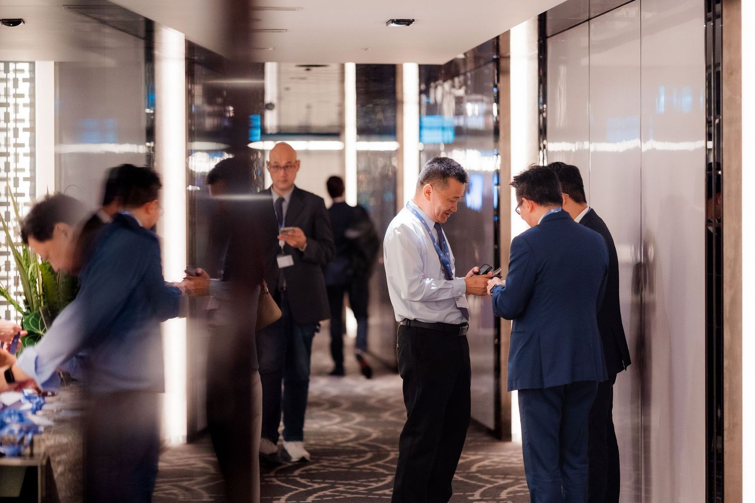 Business professionals gathered together for a corporate group photo in a modern office setting.