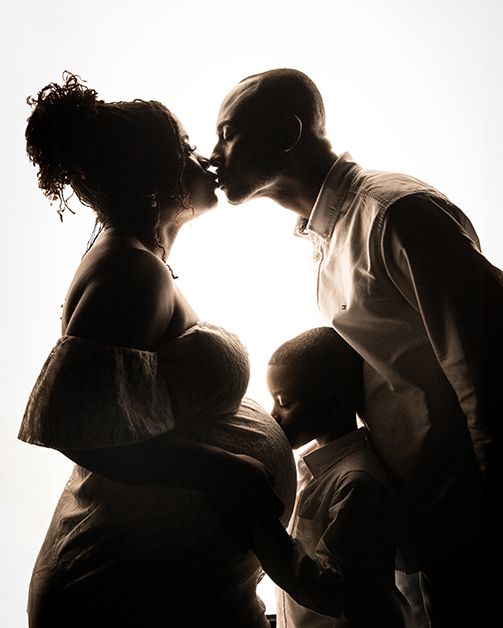 Silhouetted figures in romantic embraces create a series of intimate backlit portraits against a white background.