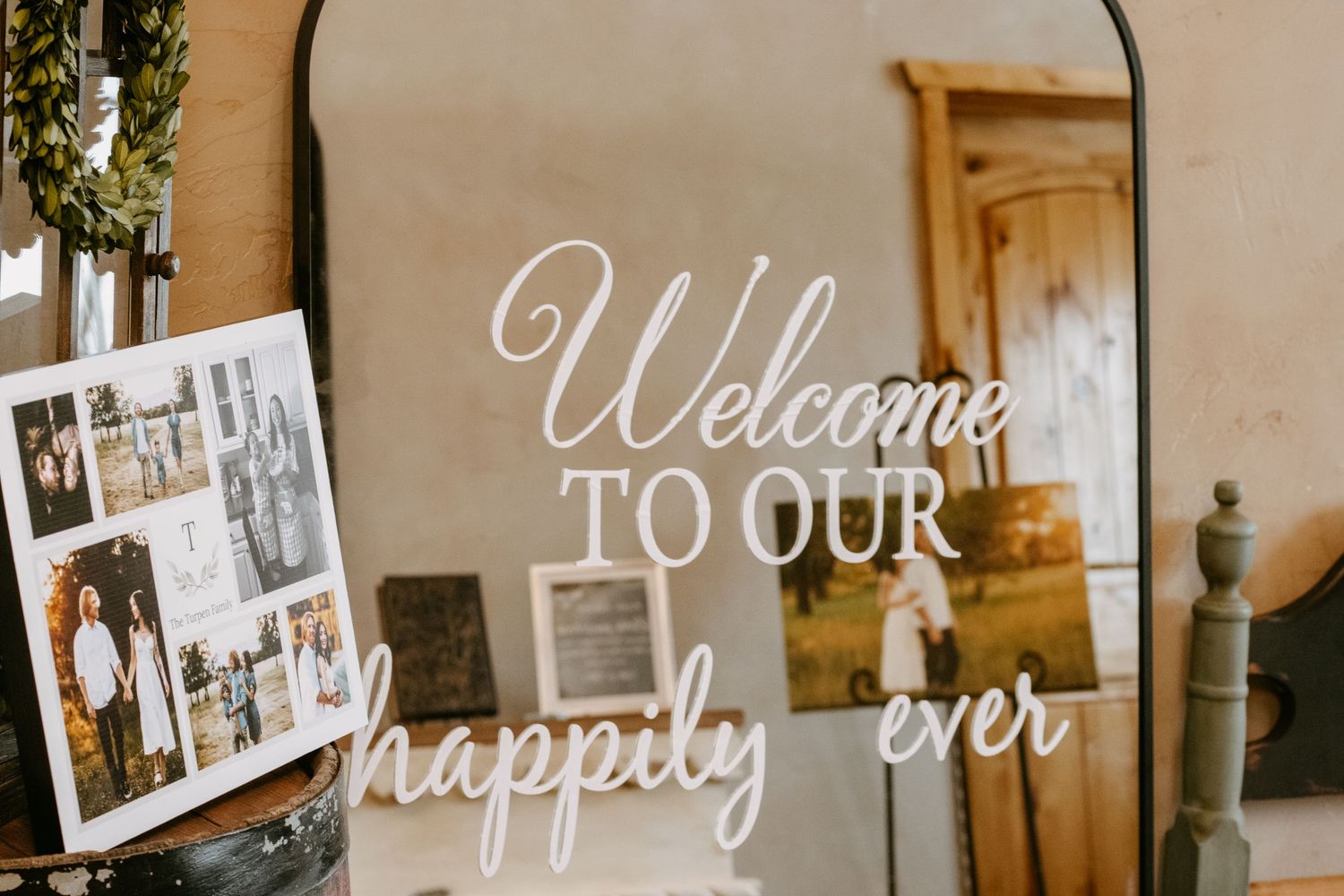 Mirror with wedding welcome sign reading Welcome to Our Happily Ever After, displayed beside a photo collage.