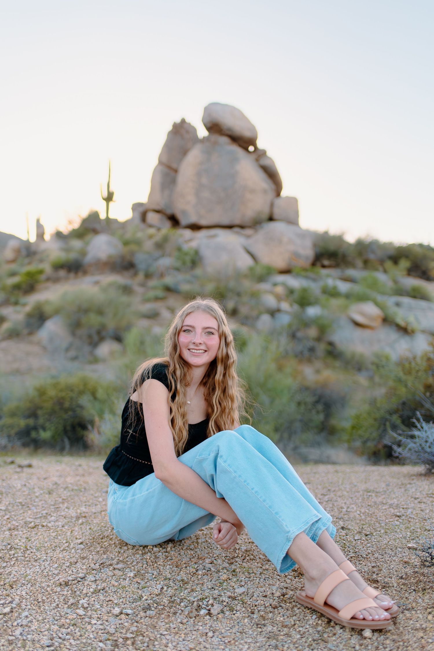 Image of a high school senior taking her senior photos  out in the desert at the McDowell Sonoran Preserve in Scottsdale, Arizona.