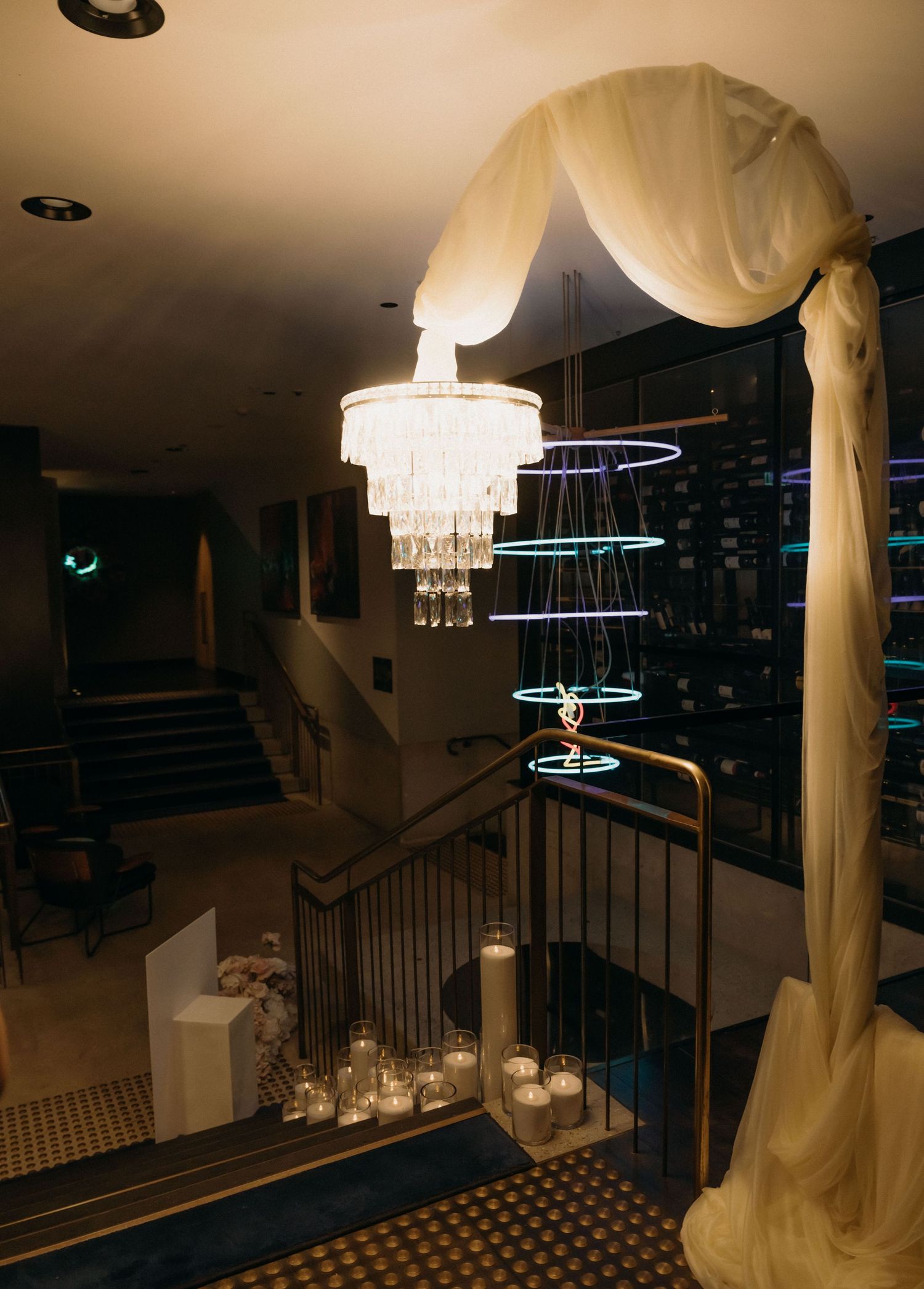 Elegant place card settings and table decor at a formal event with warm lighting and luxurious details.