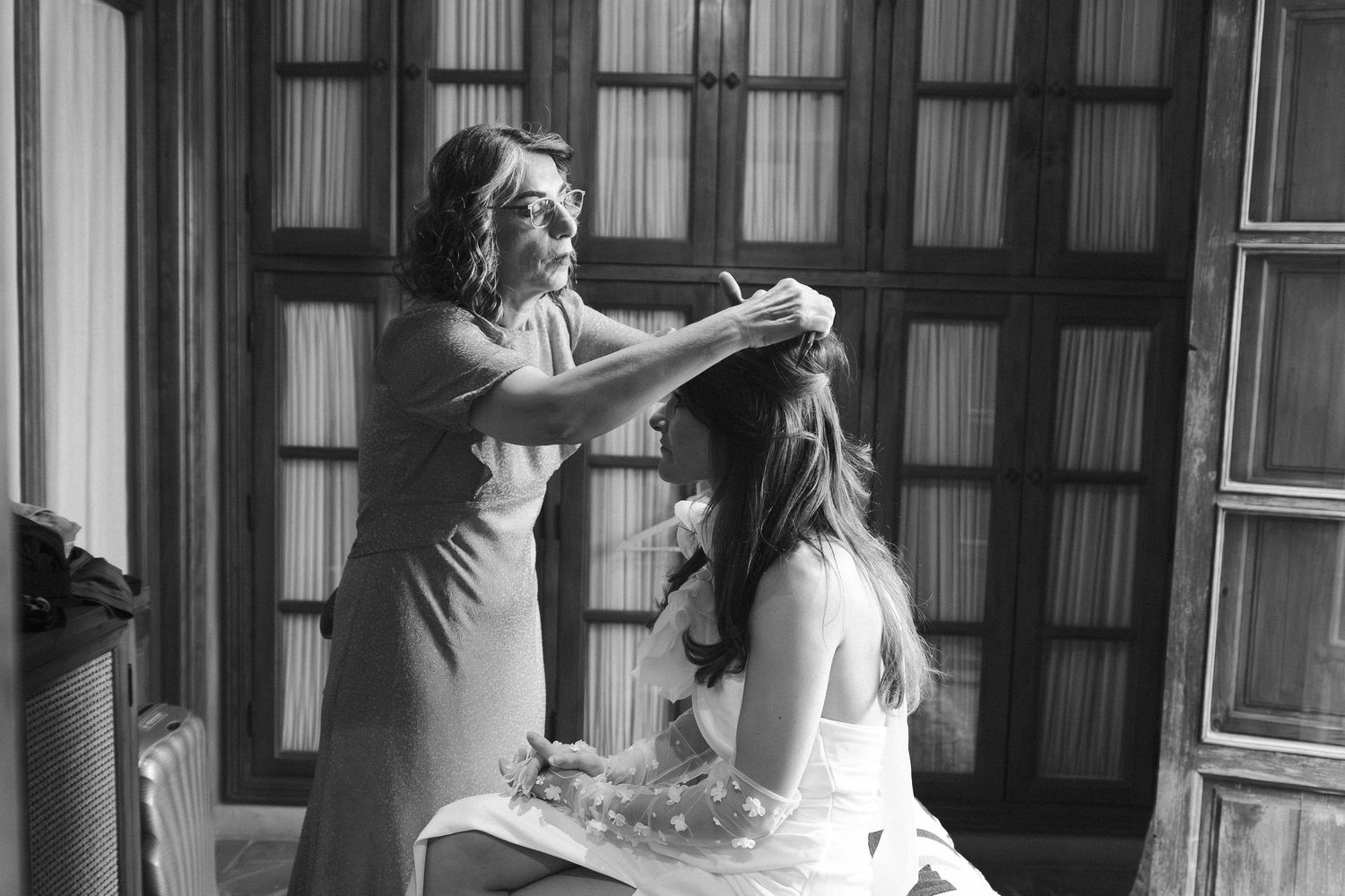 A black and white photo sequence showing a person in a dress spinning and twirling in an elegant dance motion.