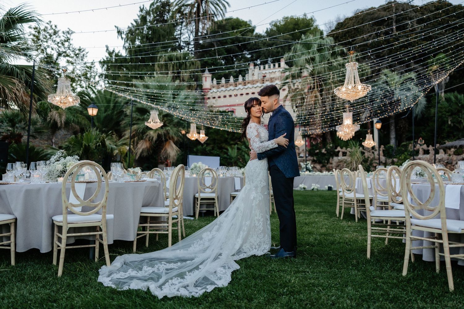 Close-up romantic portrait of couple sharing intimate moment among white flowers.
