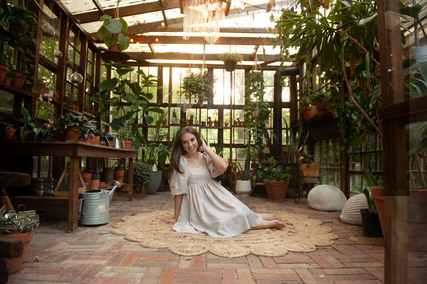 A dreamy greenhouse interior with terracotta tiles, potted plants, and a flowing white dress on a vintage rug.