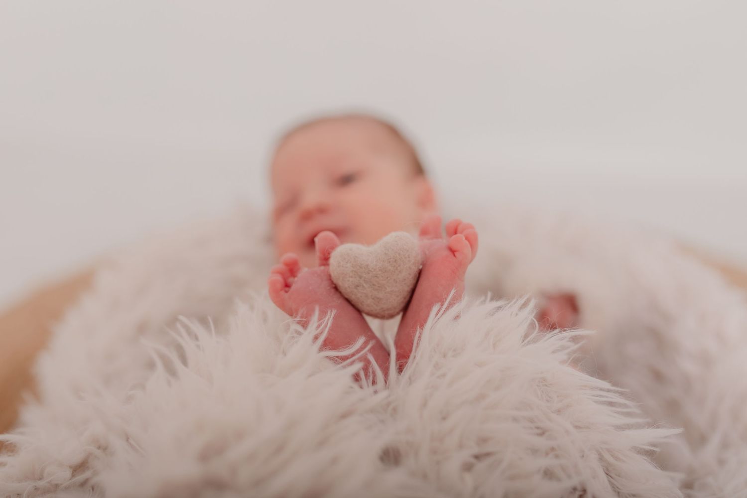 Newborn baby sleeping peacefully on soft white textured blanket. Photographer. Hull. East Yorkshire. Photography