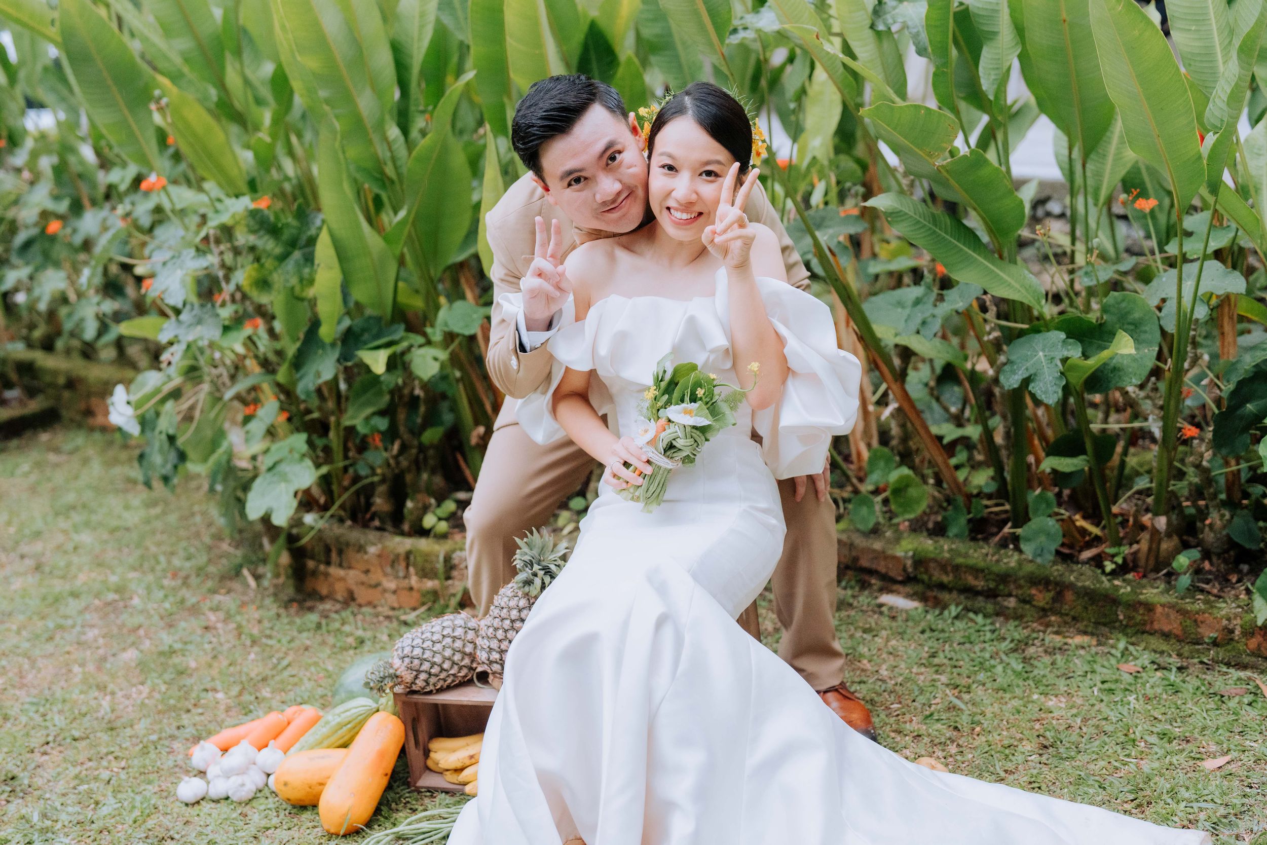 A couple shares a romantic moment in a garden setting during an outdoor wedding photoshoot.
