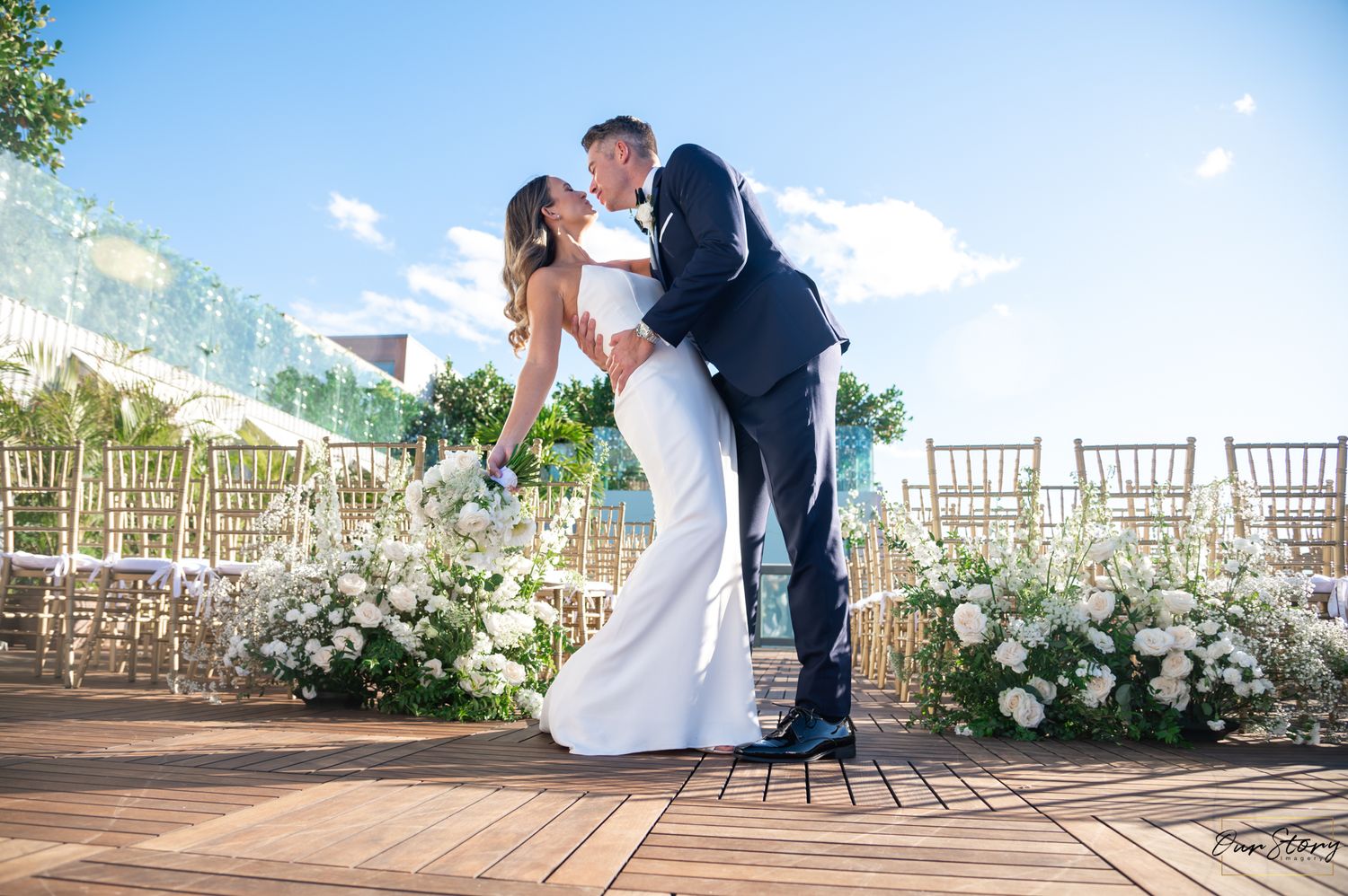 The bride and groom share a kiss at the rooftop wedding at The Ray Hotel photographed by wedding photographers in South Florida.