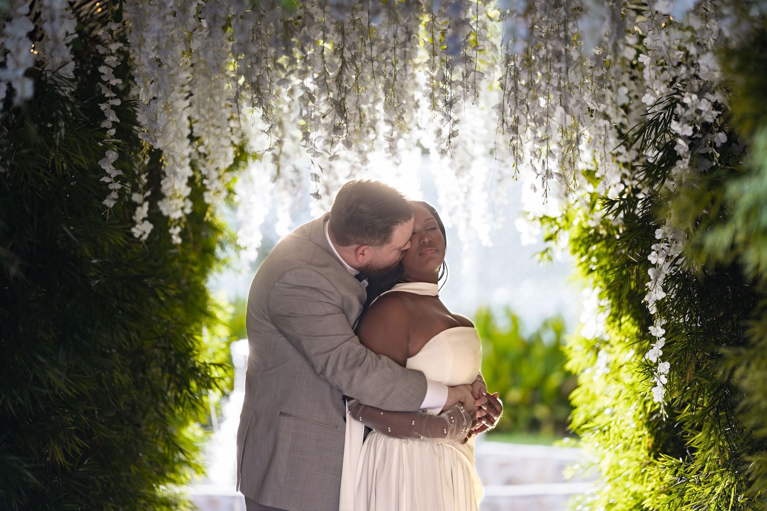 Bride and groom posing at the garden tunnel at The Orchard by Wedgewood Weddings in Menifee, California