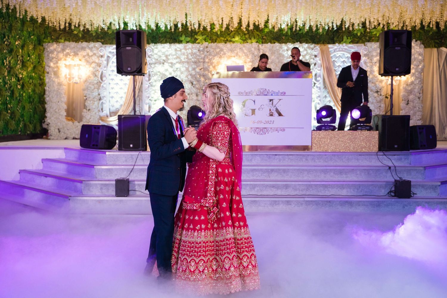 Sikh Groom and english Bride's first dance with low fog and smiling at the guest's