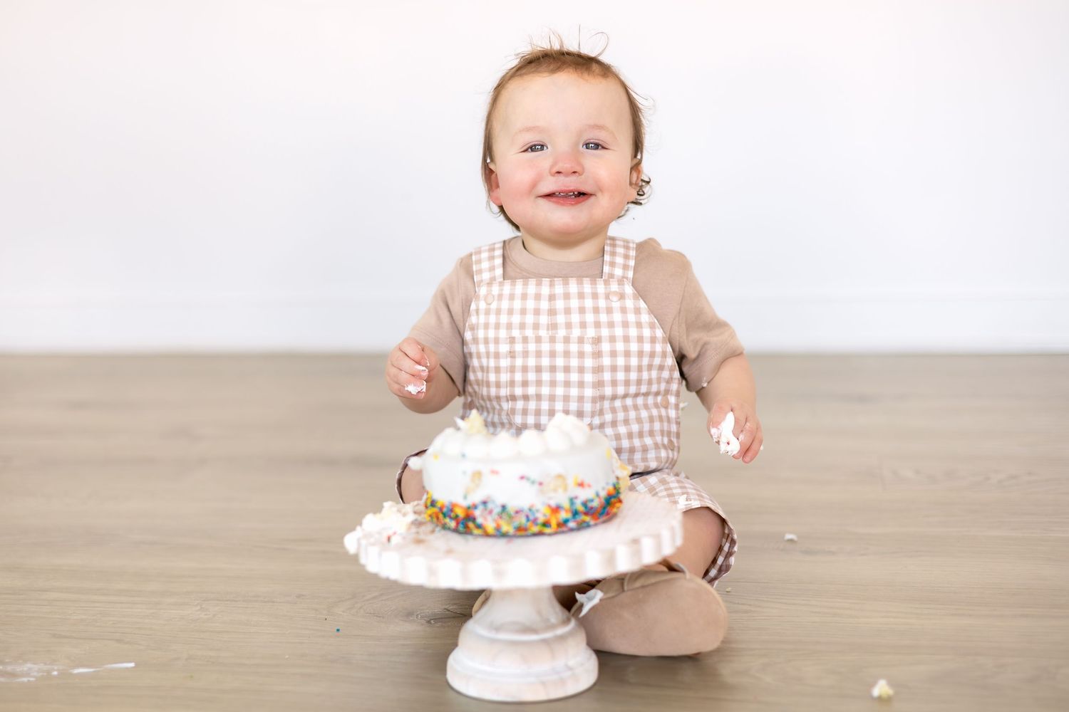 Little boy smiling during his first birthday cake smash session at Birdie & Co Studio in Athens GA