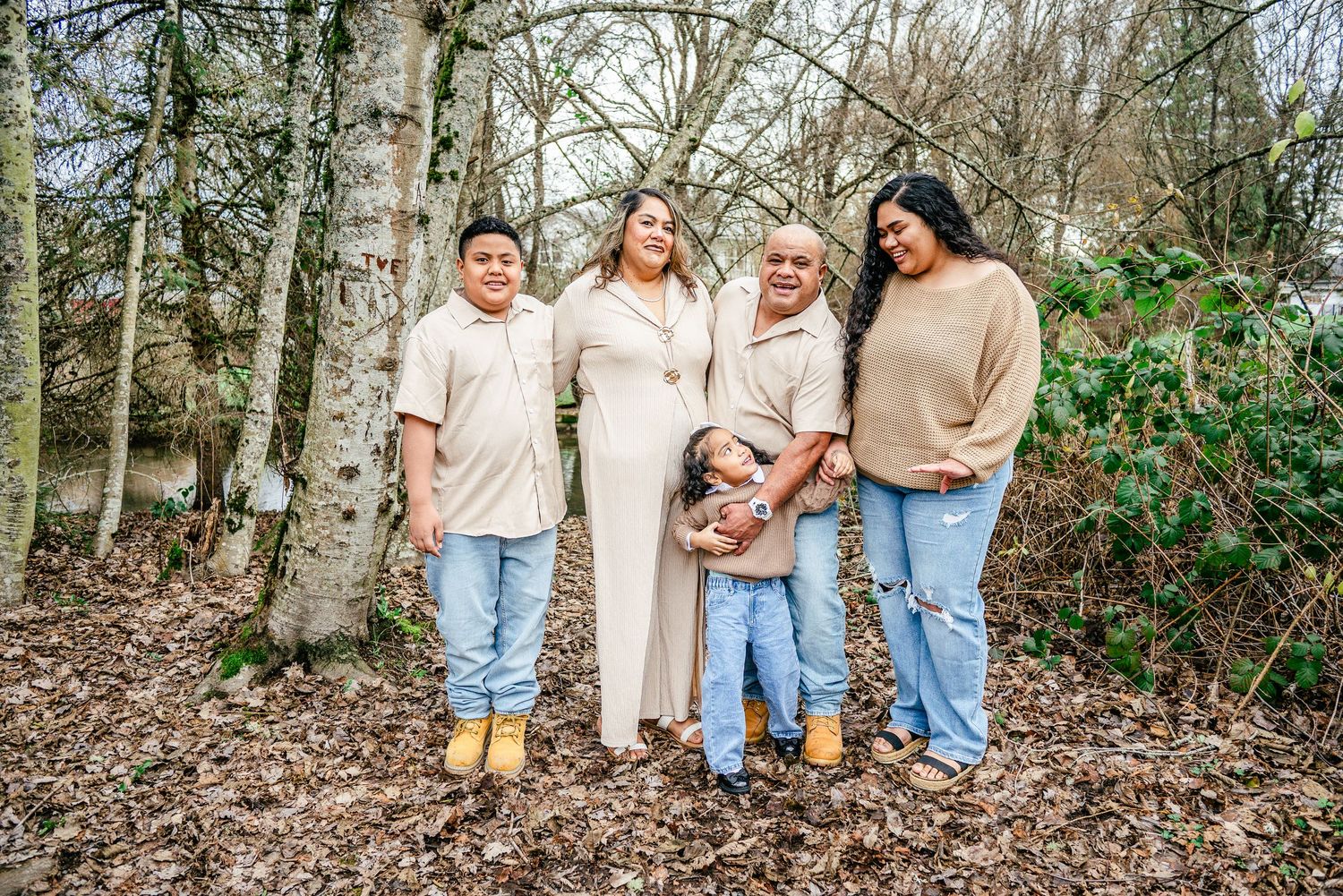 Family of five posing together during a winter family photo session at DeCoursey Park in Puyallup, Washington