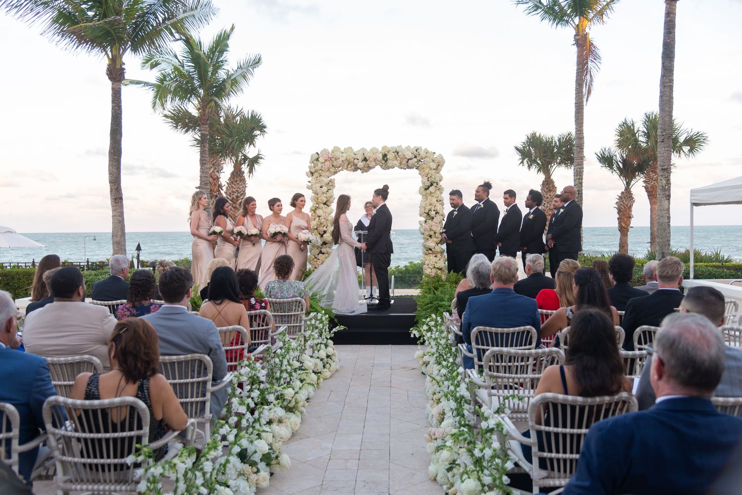 Elegant beachside “I do” at a luxury Palm Beach venue—soft ocean breeze, golden light, and timeless romance captured beautifully.