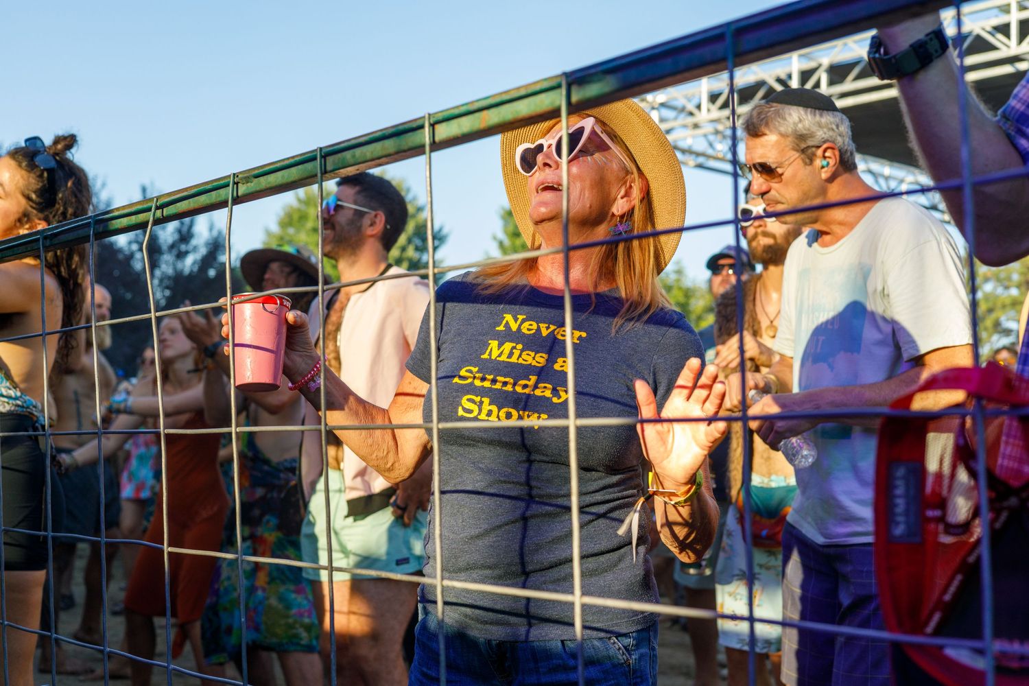 Festival attendees wait in line behind a metal barrier for the High Sierra Music Festival.