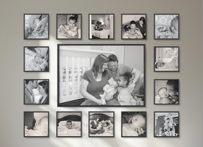 Detailed view of a black & white family photo gallery wall featuring a central portrait surrounded by newborn, and family moments