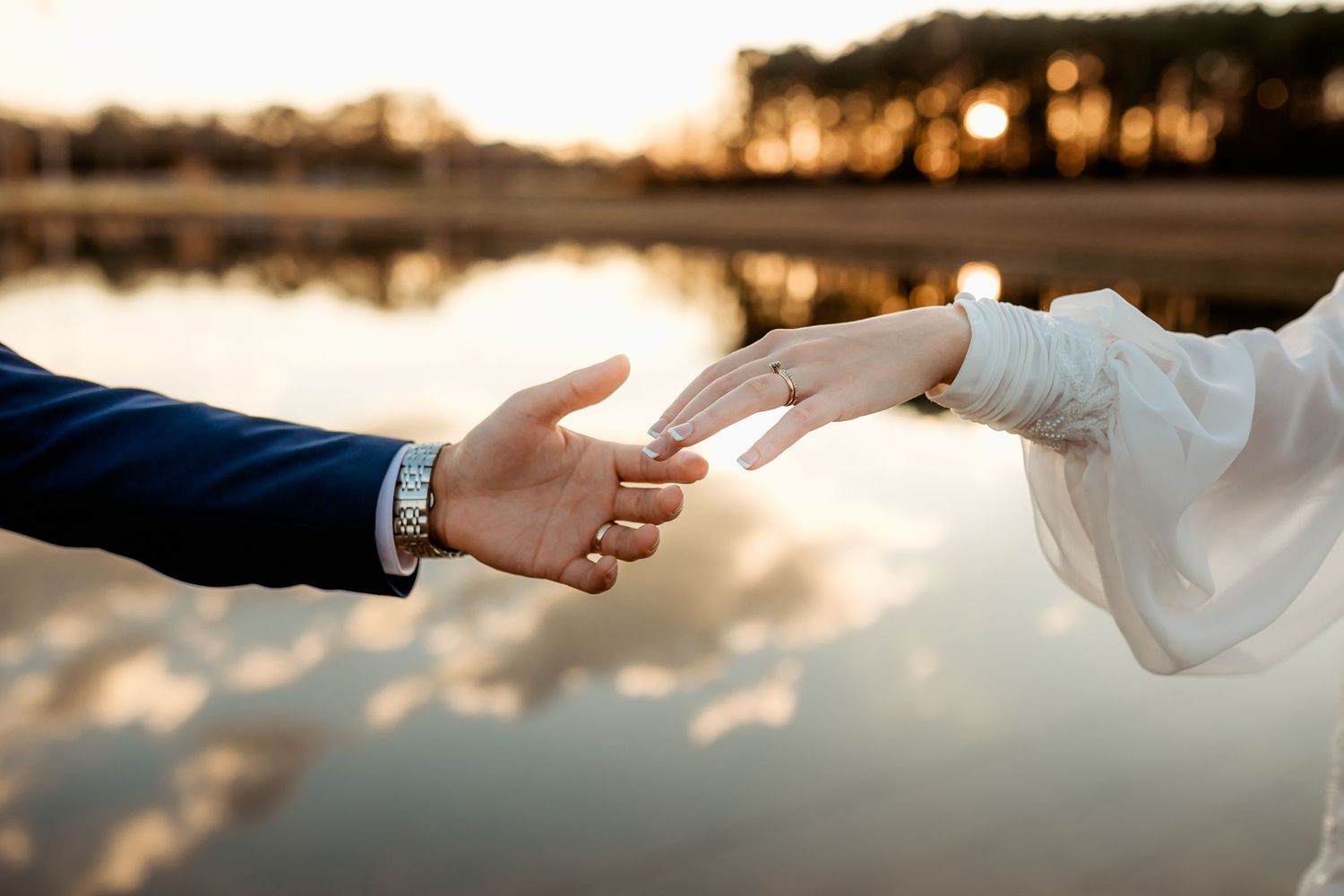 Romantic wedding photo of a couple embracing in warm sunlight with elegant text overlay and soft watercolor background.