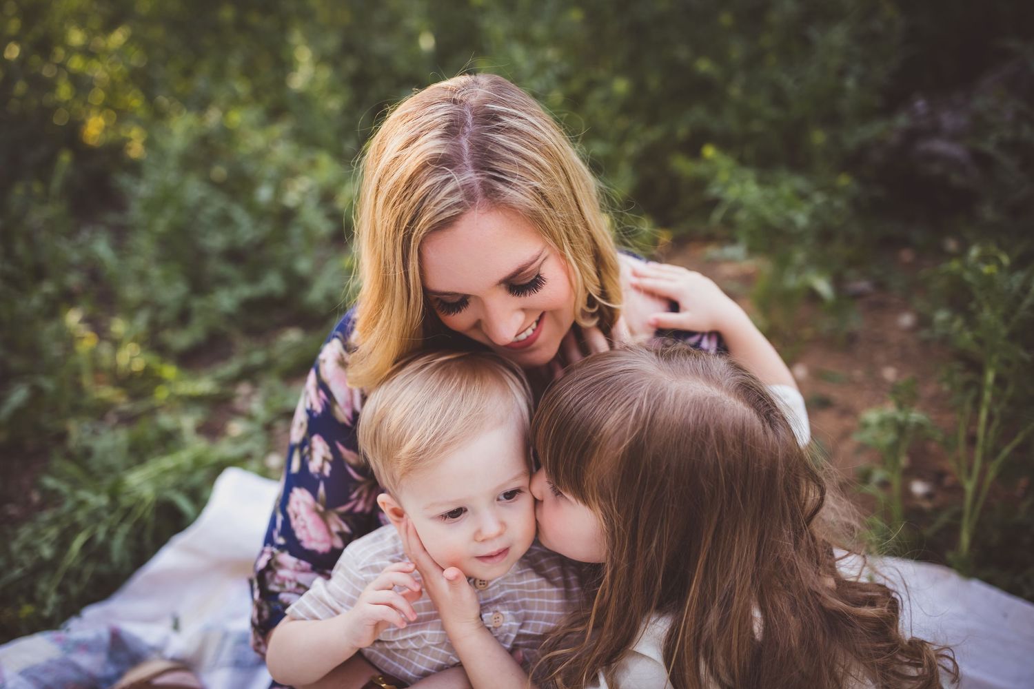 A mother and daughter share tender moments together outdoors during a lifestyle photography session.