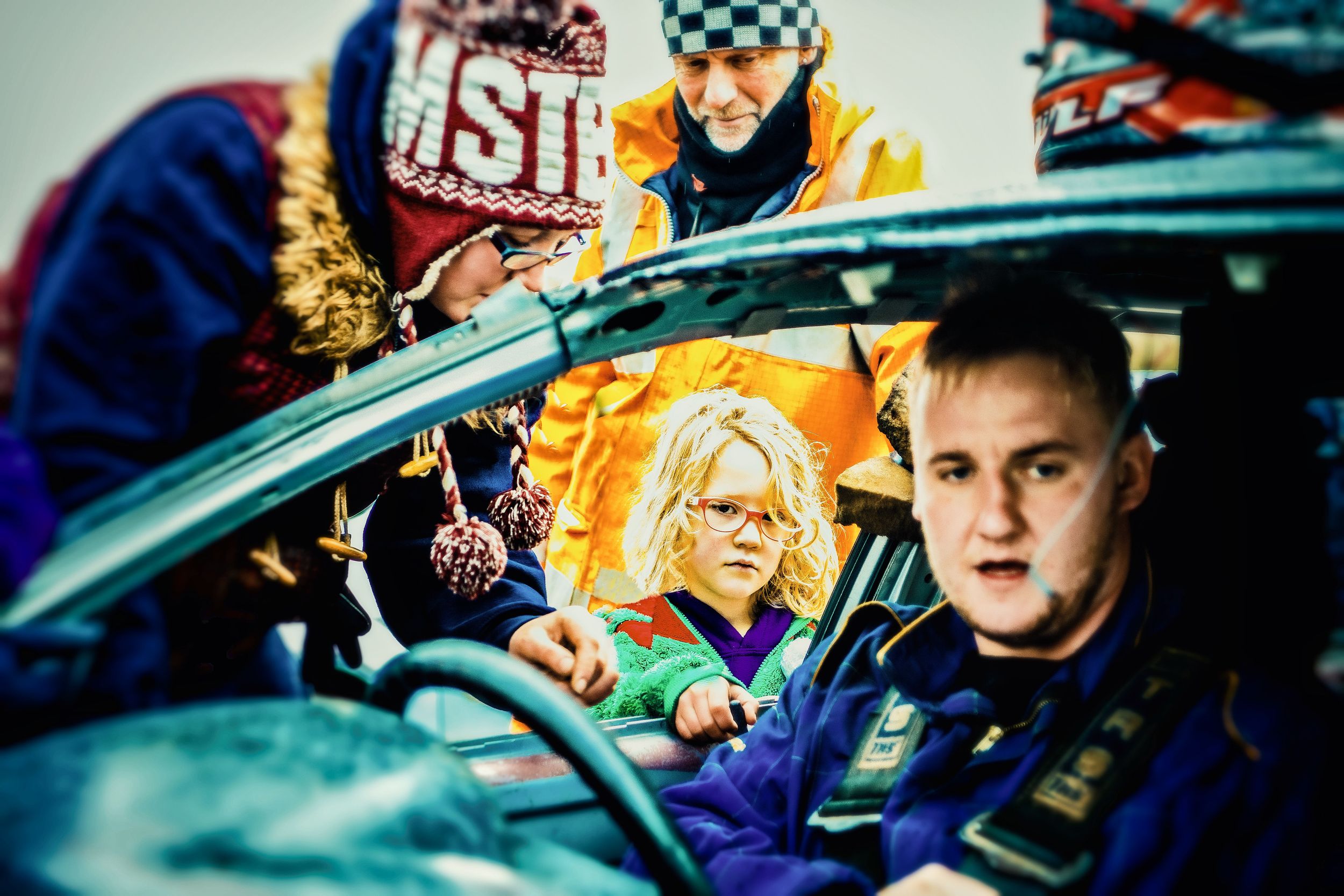 A montage of colorful motorsport racing images showing cars, crews, and spectators at a racing event.