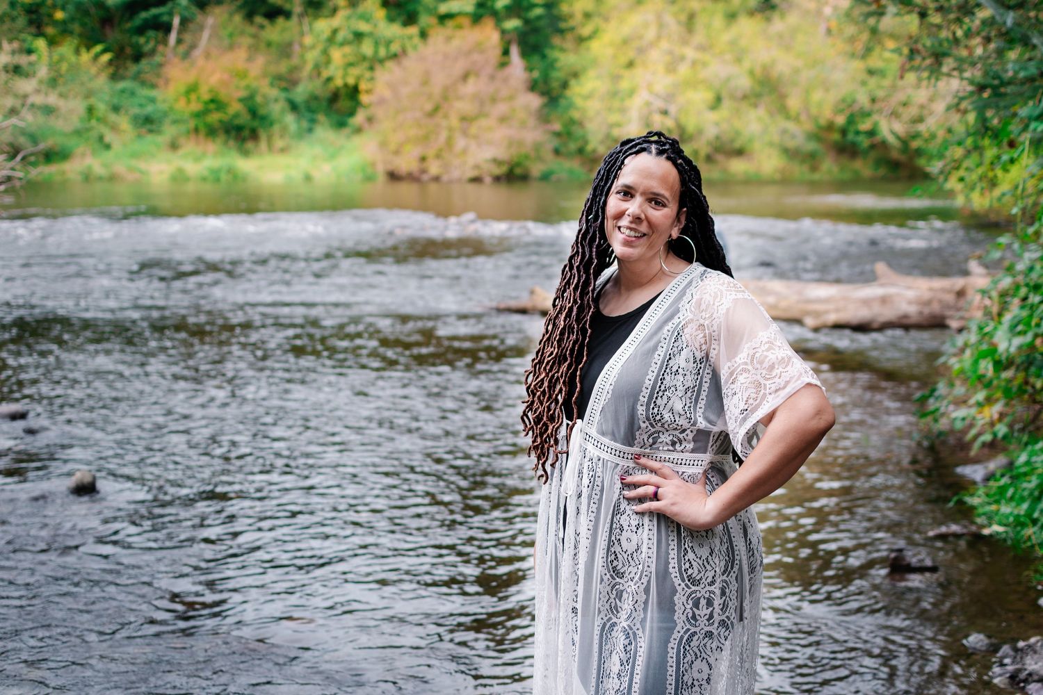 Woman celebrating her 40th birthday with golden hour portraits by the river at Flaming Geyser State Park near Seattle, WA.