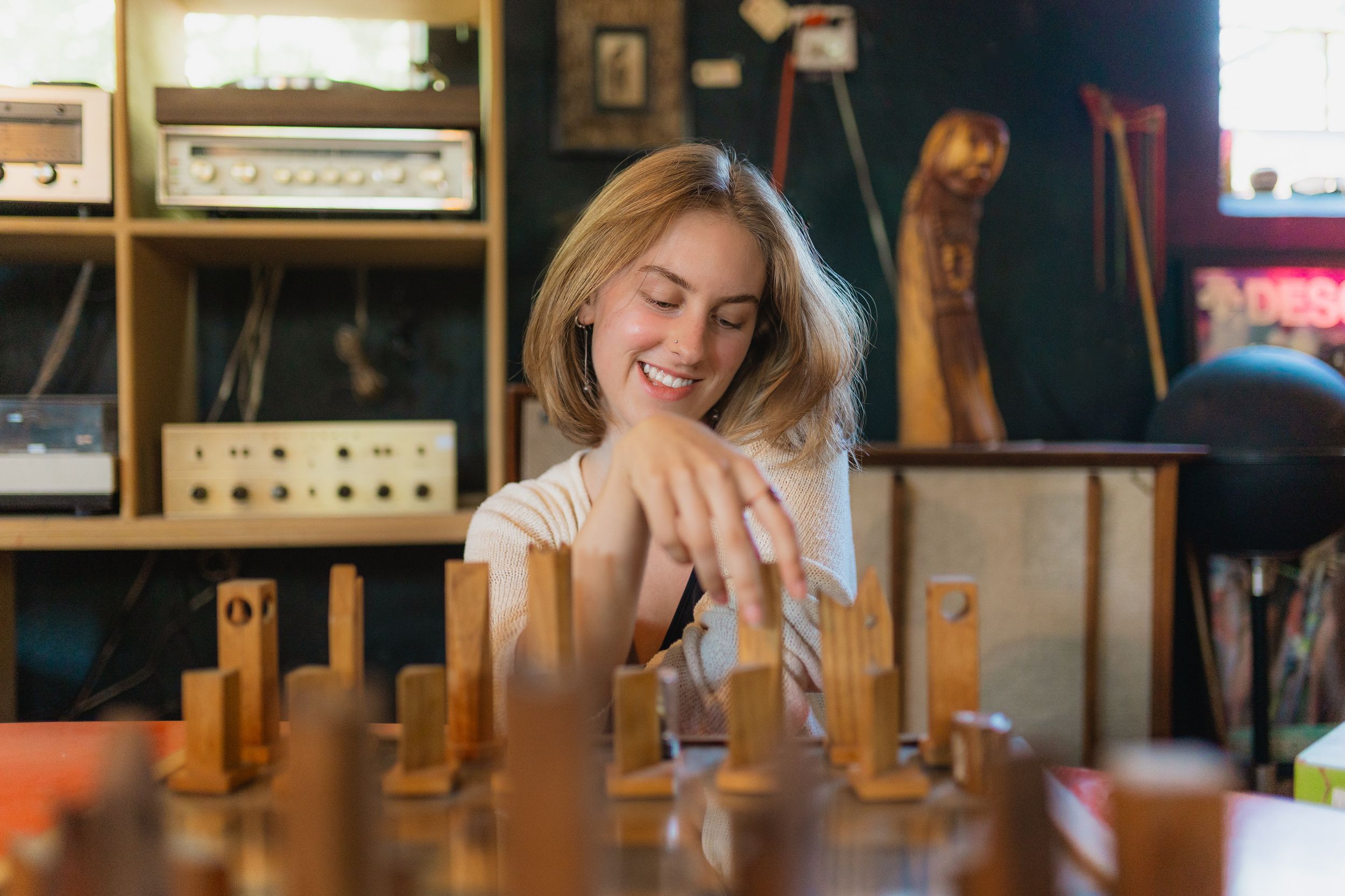A group poses together wearing white shirts against scenic mountain views in Boulder, Colorado's Flatirons landscape.