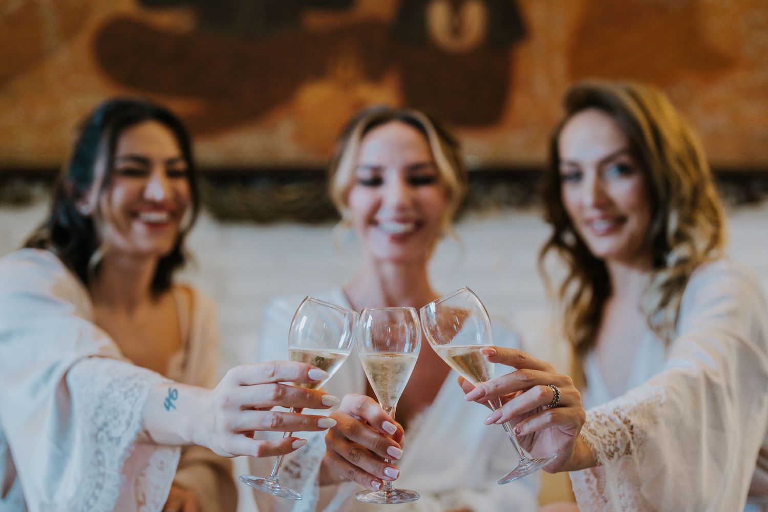Celebratory moment with champagne glasses clinking during outdoor gathering.