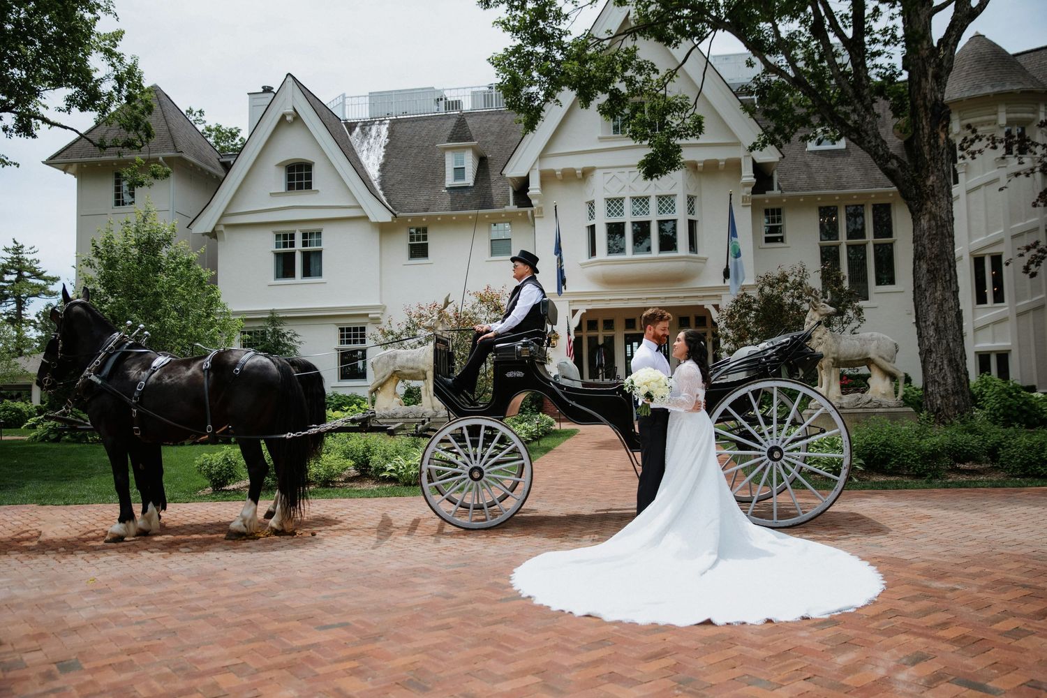 White vintage carriage and elegant mansion create a romantic wedding venue backdrop.