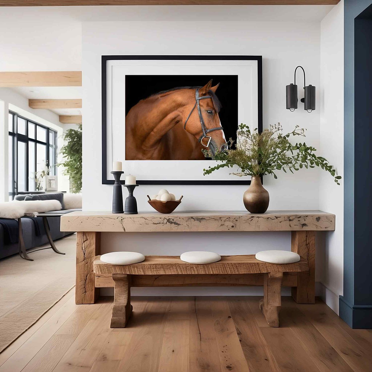 A large framed equine portrait in a modern minimalist interior with light wood flooring and rustic wood beam accents against white walls.