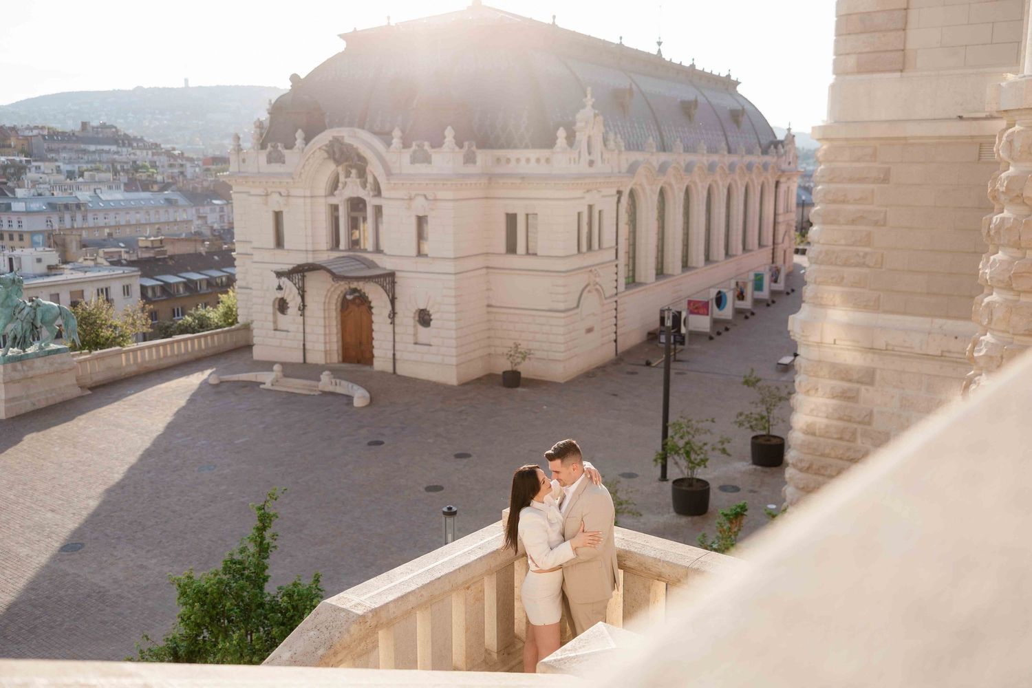 Elegant couple walking in Buda Castle during sunrise photoshoot