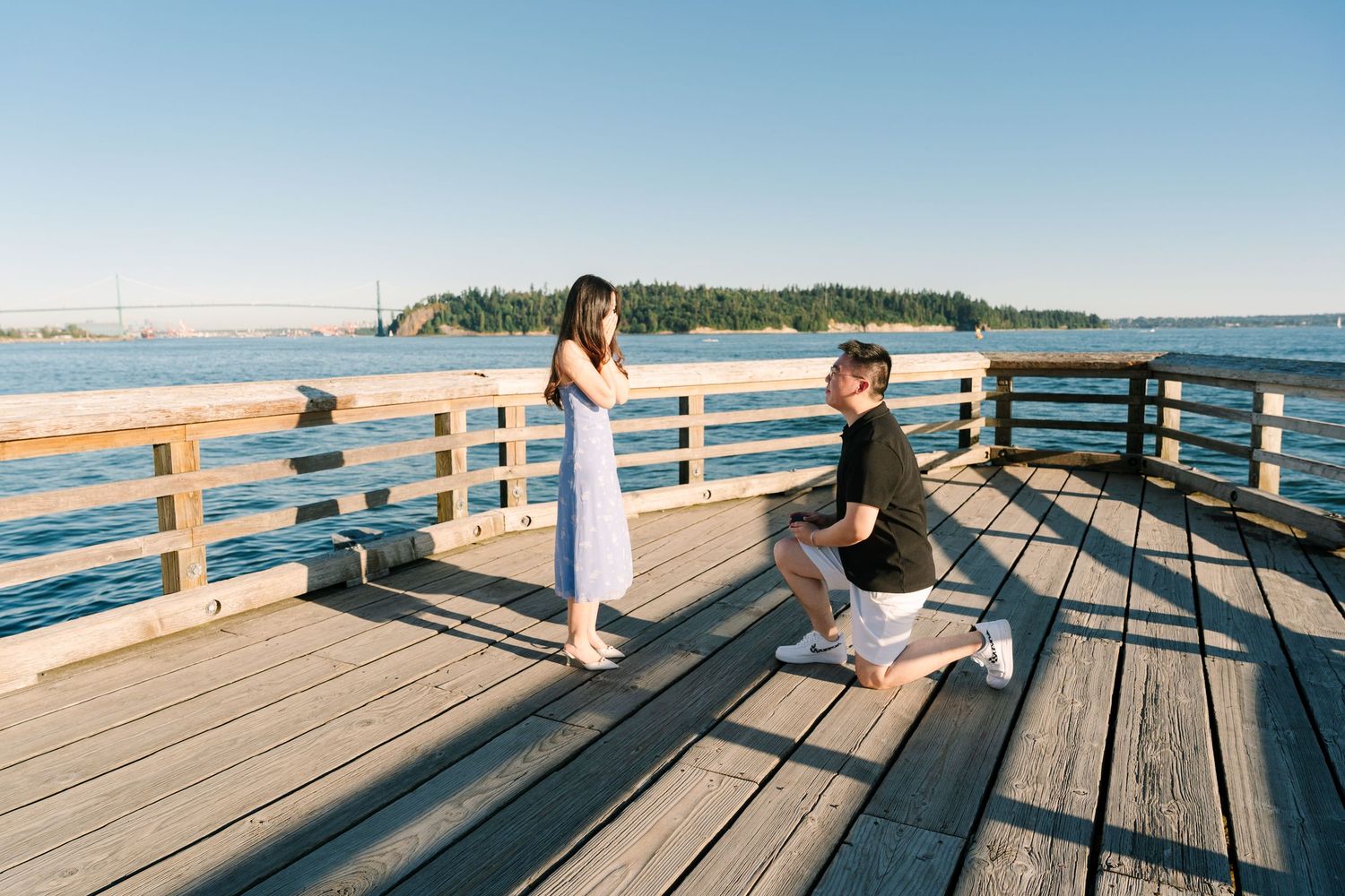 A panoramic sequence showing someone sitting on a wooden pier overlooking a calm lake during sunset.