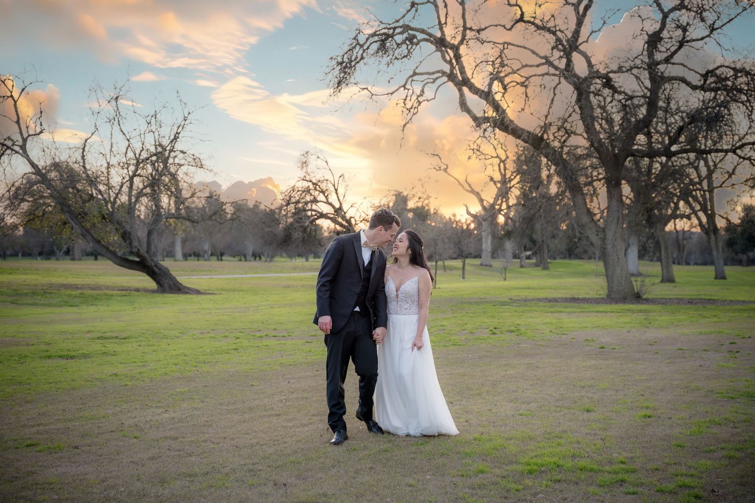 Sunset portrait of the bride a groom walking through the gulf course of the Yolo Fliers Club in Woodland, California. Photo by Ashley Baeza.