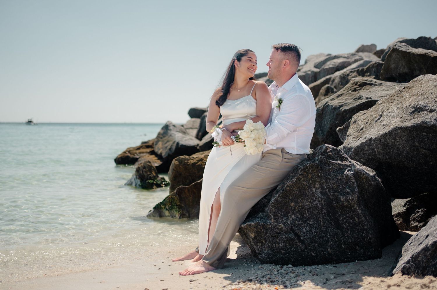 Newlyweds share romantic moments in a series of outdoor wedding photos on a lush green lawn.