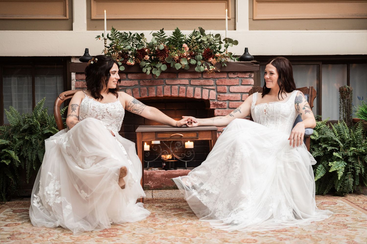 Portrait of brides holding hands.