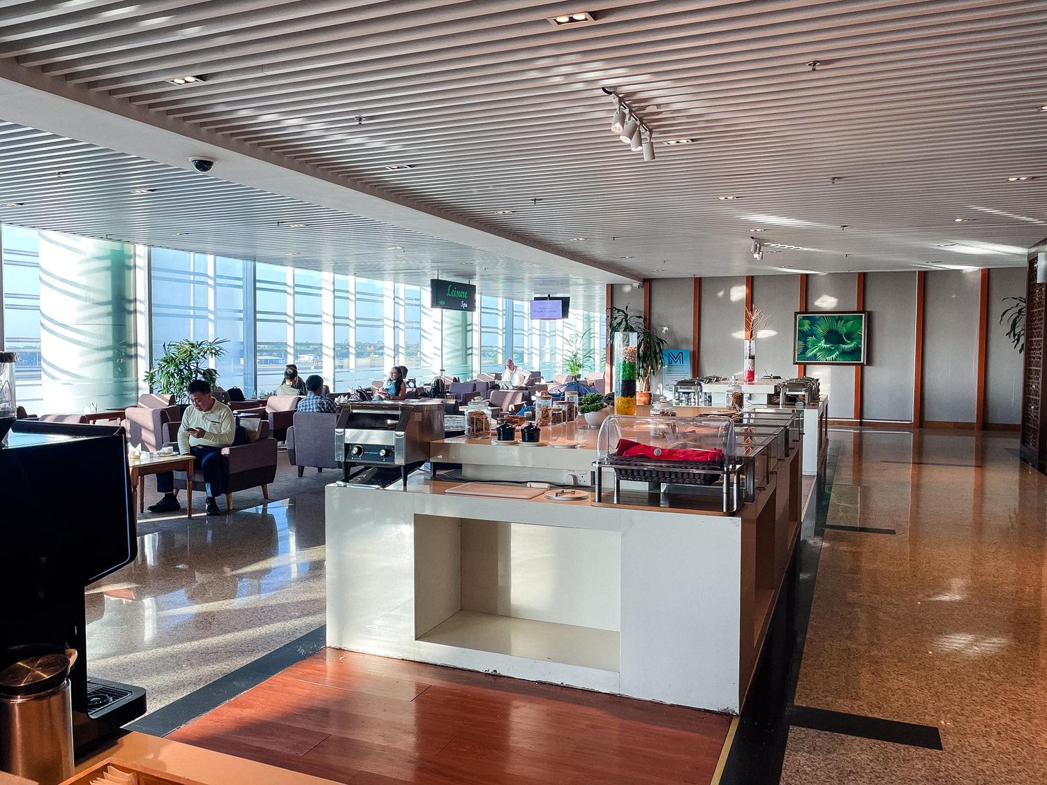 Modern office interior with glass walls, sleek furniture, and bright lighting showcases an open workspace design.