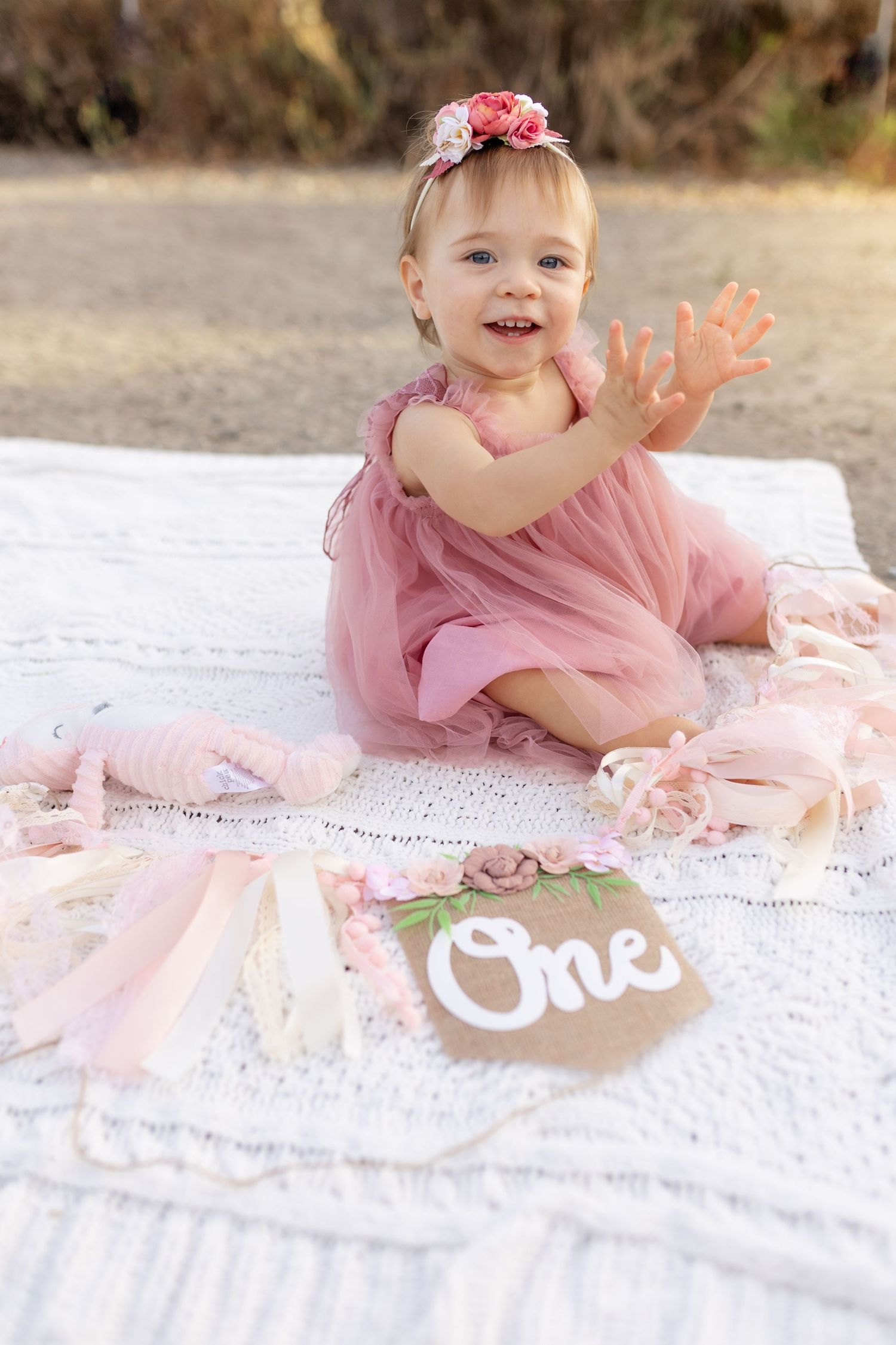 One year old girl clapping in a tutu